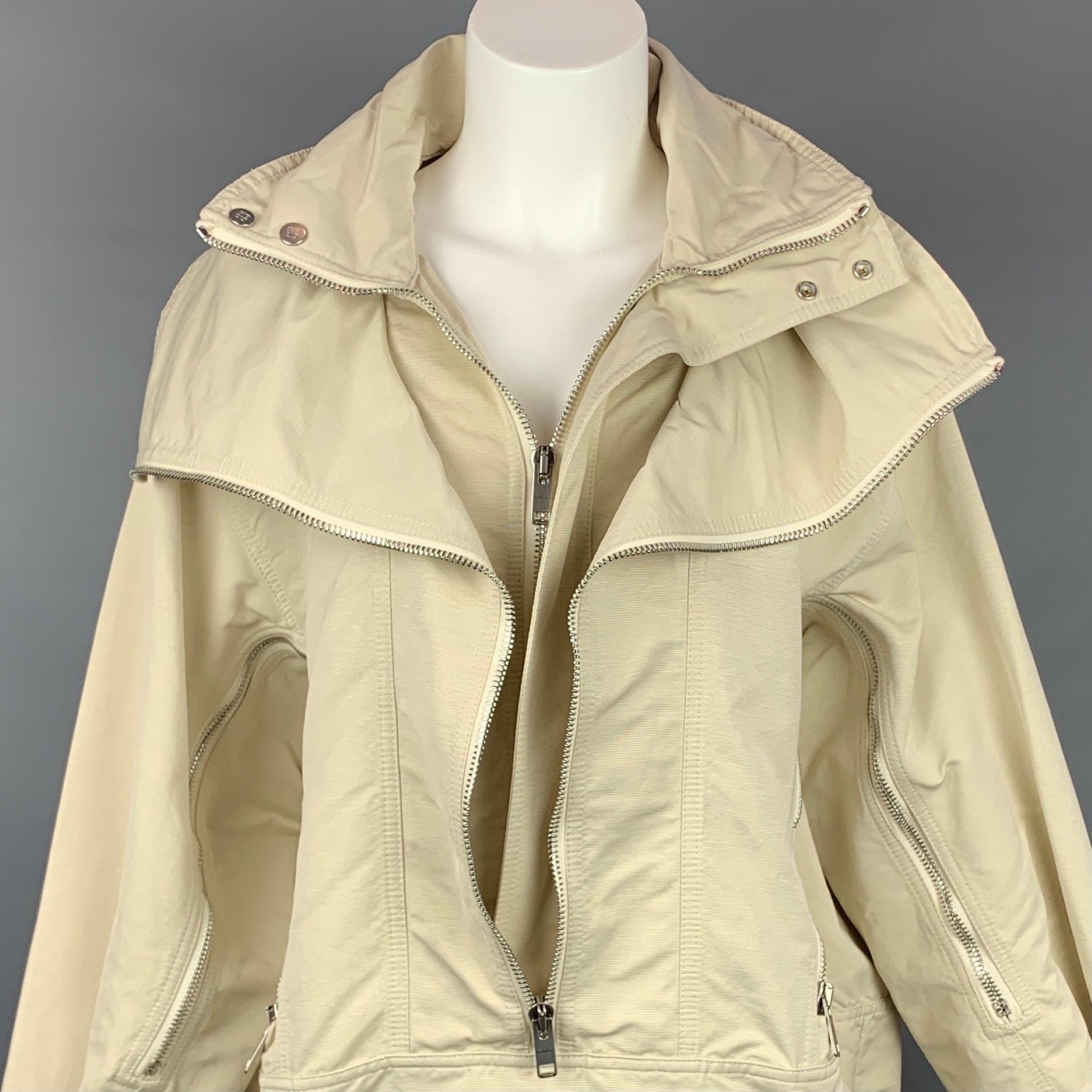 GIVENCHY Spring Summer 2021 jacket comes in a beige cotton polyester featuring a windbreaker style, oversized fit, fold over hood, double collar, zip detail at sleeves, and hook fastening tabs on the cuffs and hems. Made in Portugal.

Very Good