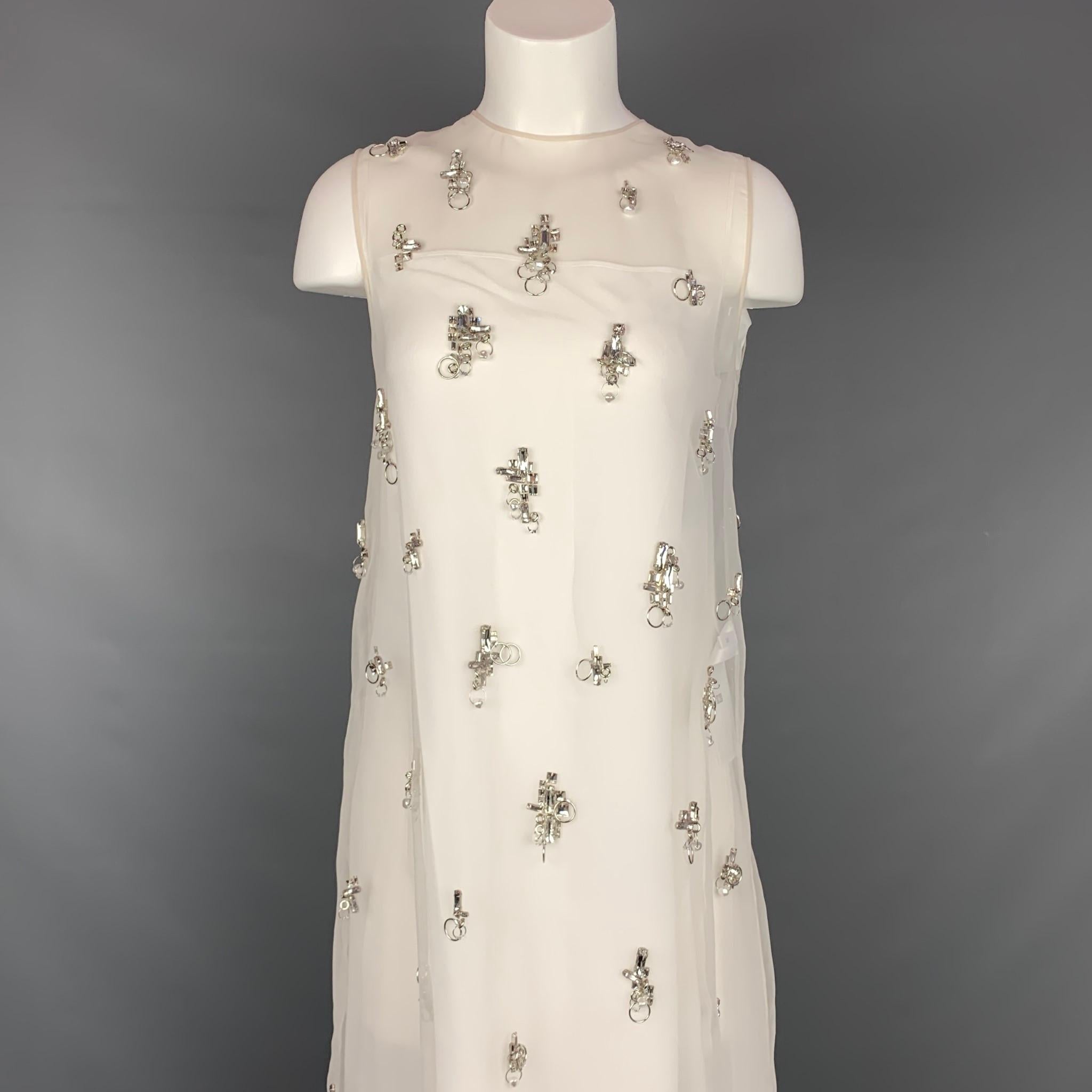 GIVENCHY Spring Summer 2021 dress comes in a cream organza polyester with a slip liner featuring a shift style, crystal accents with hoops, faux pearls, back leather trim, and a exposed back zipper closure. Made in France.

New With Tags. 
Marked: