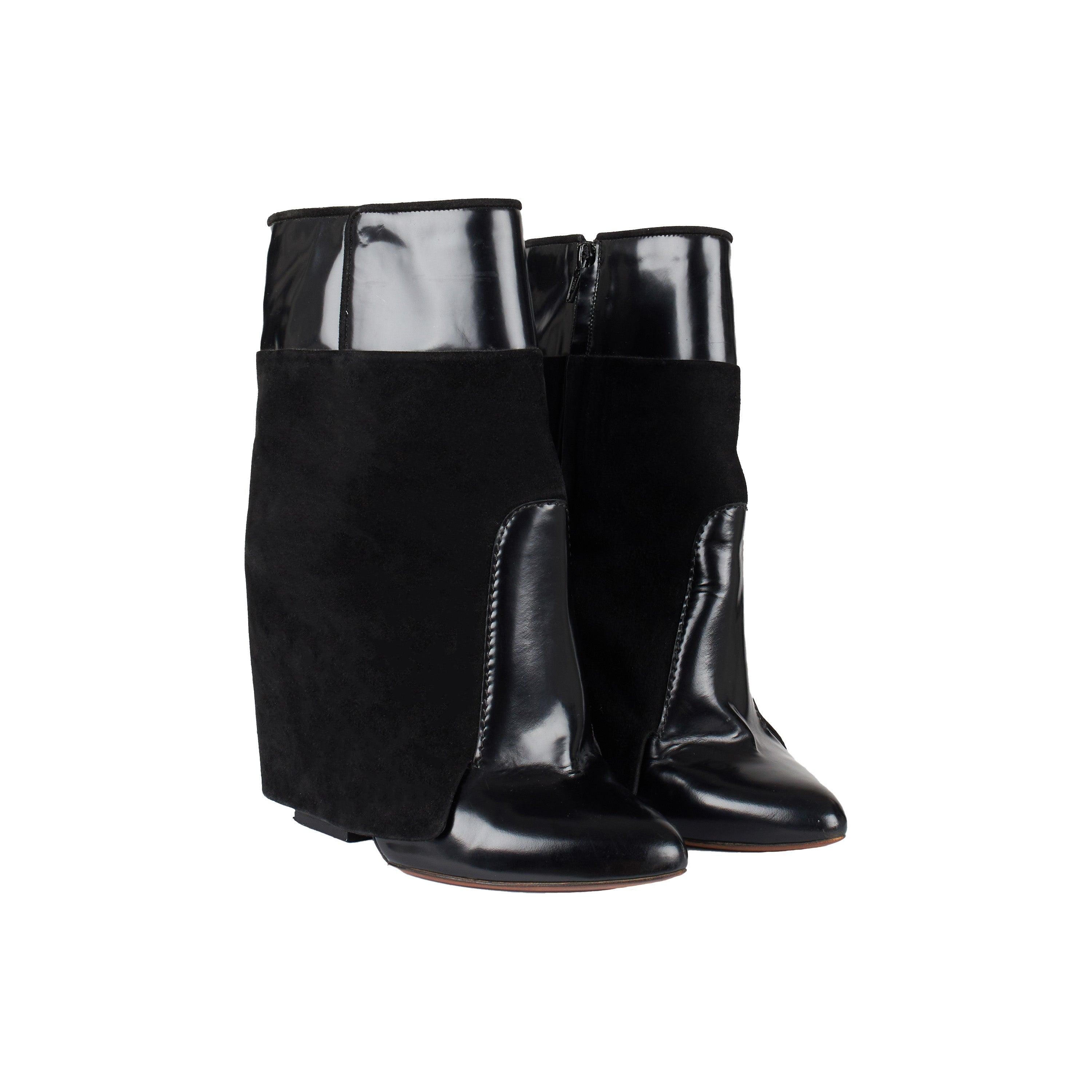 These Givenchy ankle boots make a statement with their eye-catching blend of suede and patent leather. Equipped with hidden heels and a side zipper closure, the boots provide a secure, comfortable fit for all day wear. 
 Remarks: There is a spot on