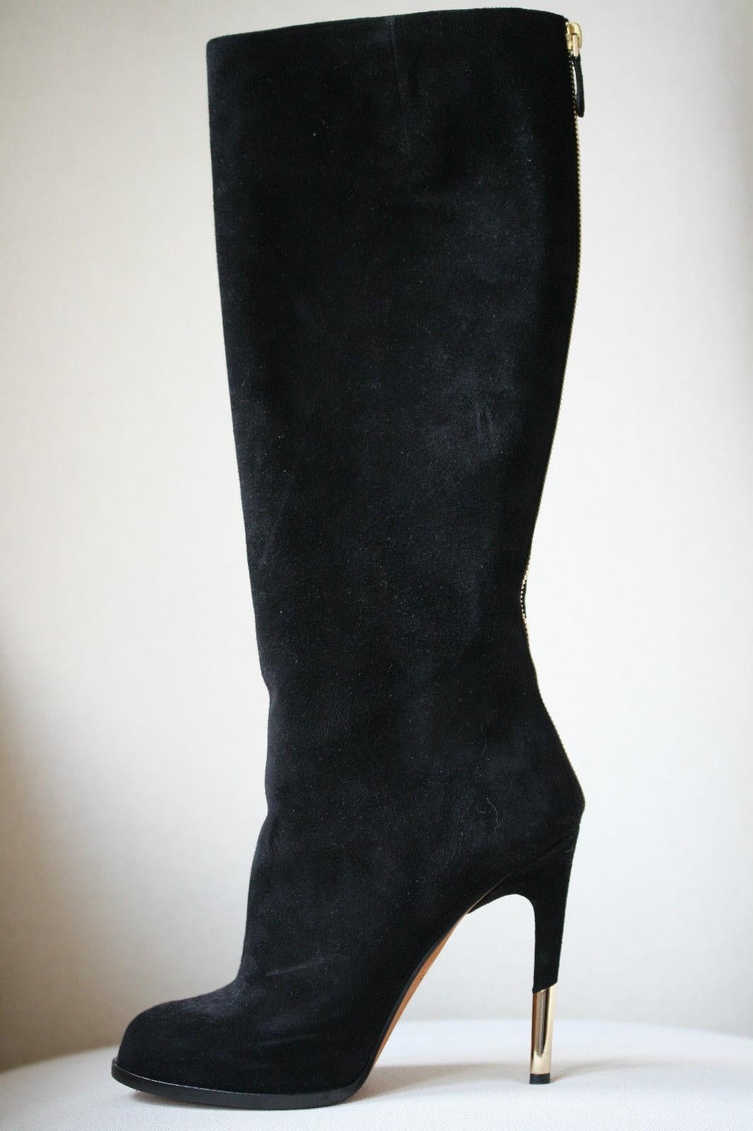 Givenchy opts for a signature look with these knee-high boots. The supple black suede is cut with a slender high heel for a seductive look, while the exposed zip fastening adds rebellious appeal. Round toe. Zipped back fastening. 100% Calf-leather