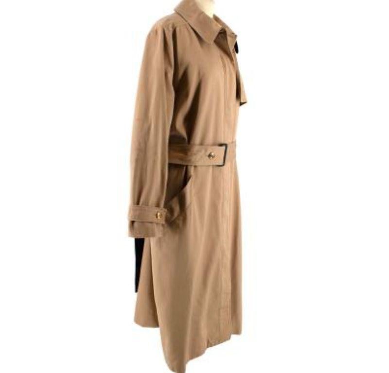 Givenchy Tan Belted Cotton Trench Coat

- Fully lined
- Gold-tone hardware
- Concealed button fastening
- Buttoned cuffs
- Black paneling on the back
- Two pockets
- Adjustable belt fastening

Material
100% Cotton
Underneath collar: 65% Cotton and