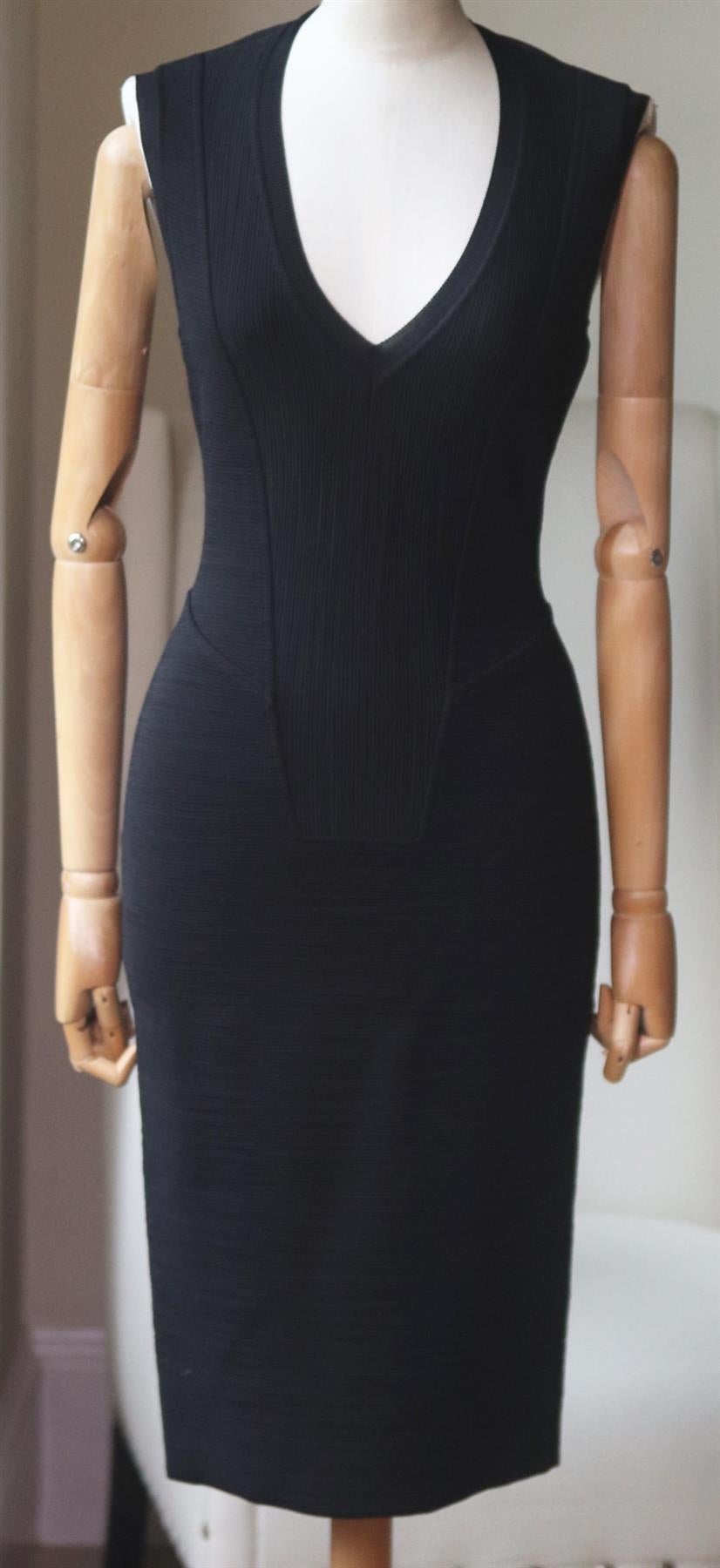 Nail the trend in Givenchy's black textured stretch-knit dress with lattering v-neckline and a contrasting waist panel ensure a sensational silhouette. Black stretch-knit. Concealed zip fastening down the back. 84% Viscose, 13% polyamide, 3%