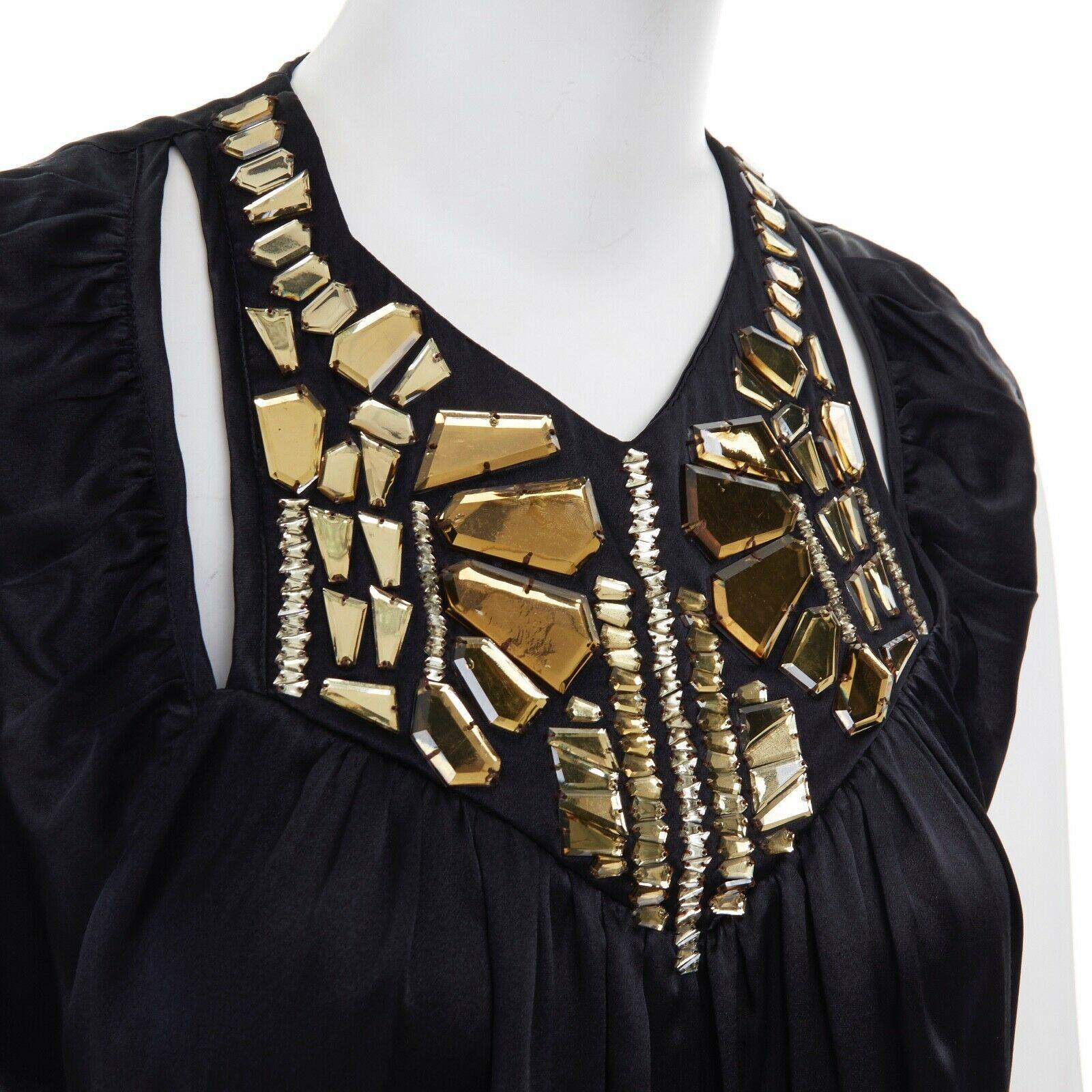 GIVENCHY TISCI 100% silk yellow acrylic applique collar sleeveless top FR38 S
GIVENCHY BY RICCARDO TISCI
100% silk. 
Black. 
Gold yellow angular cut applique at neckline. 
V-neck. 
Cut out detail. 
Ruched along neckline. 
Sleeveless top. 
Made in