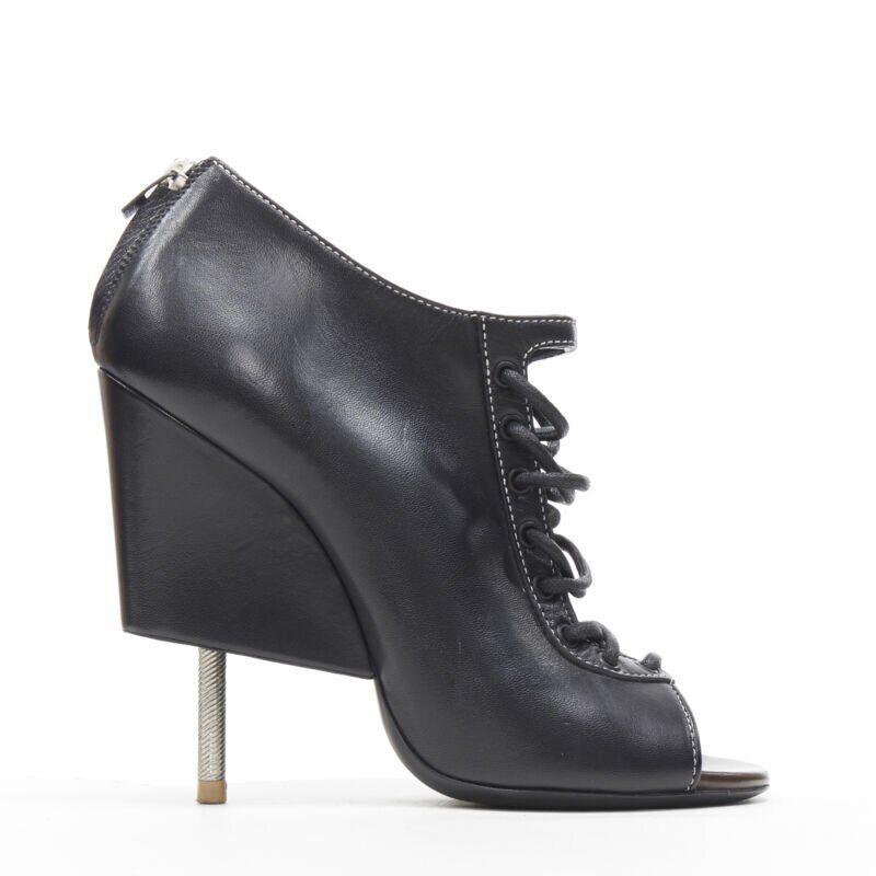 GIVENCHY TISCI black lace up open toe angular nail heel bootie EU38 US8
Reference: LNKO/A01413
Brand: Givenchy
Designer: Riccardo Tisci
Collection: Runway
Material: Leather
Color: Black
Pattern: Solid
Closure: Zip
Extra Details: Lace front design.
