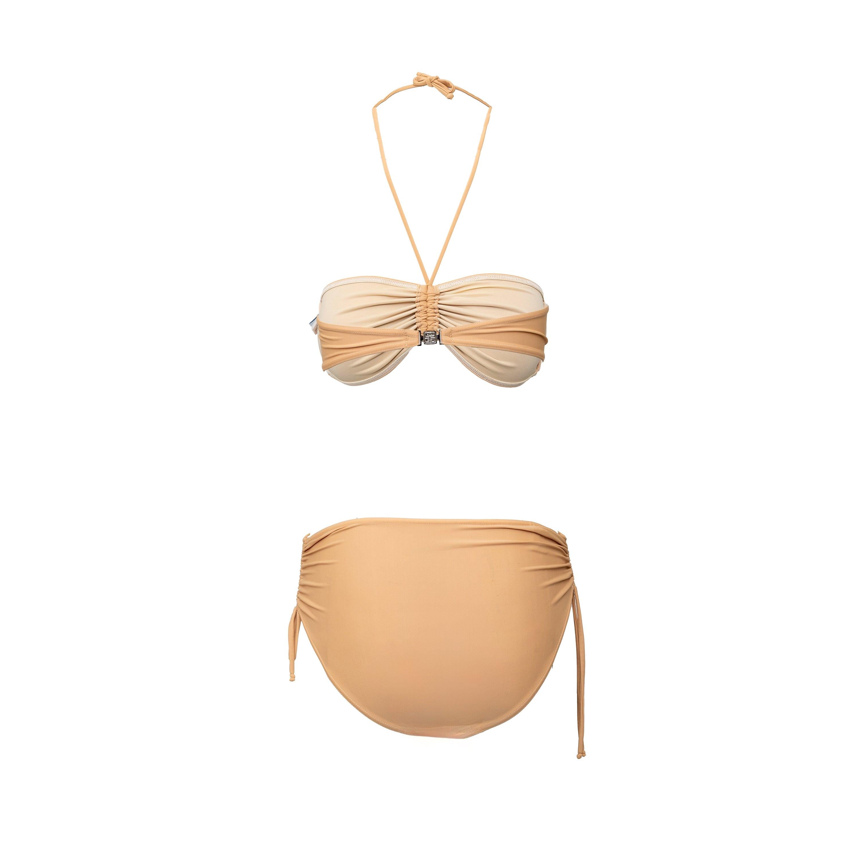 Expertly crafted, this Givenchy Tube Swimwear captures modern glamour with its tube design and beige color. Made from a blend of polyamide and elastane, it offers both stretch and support. A tie knot on the top and logo emblem on the hook closure