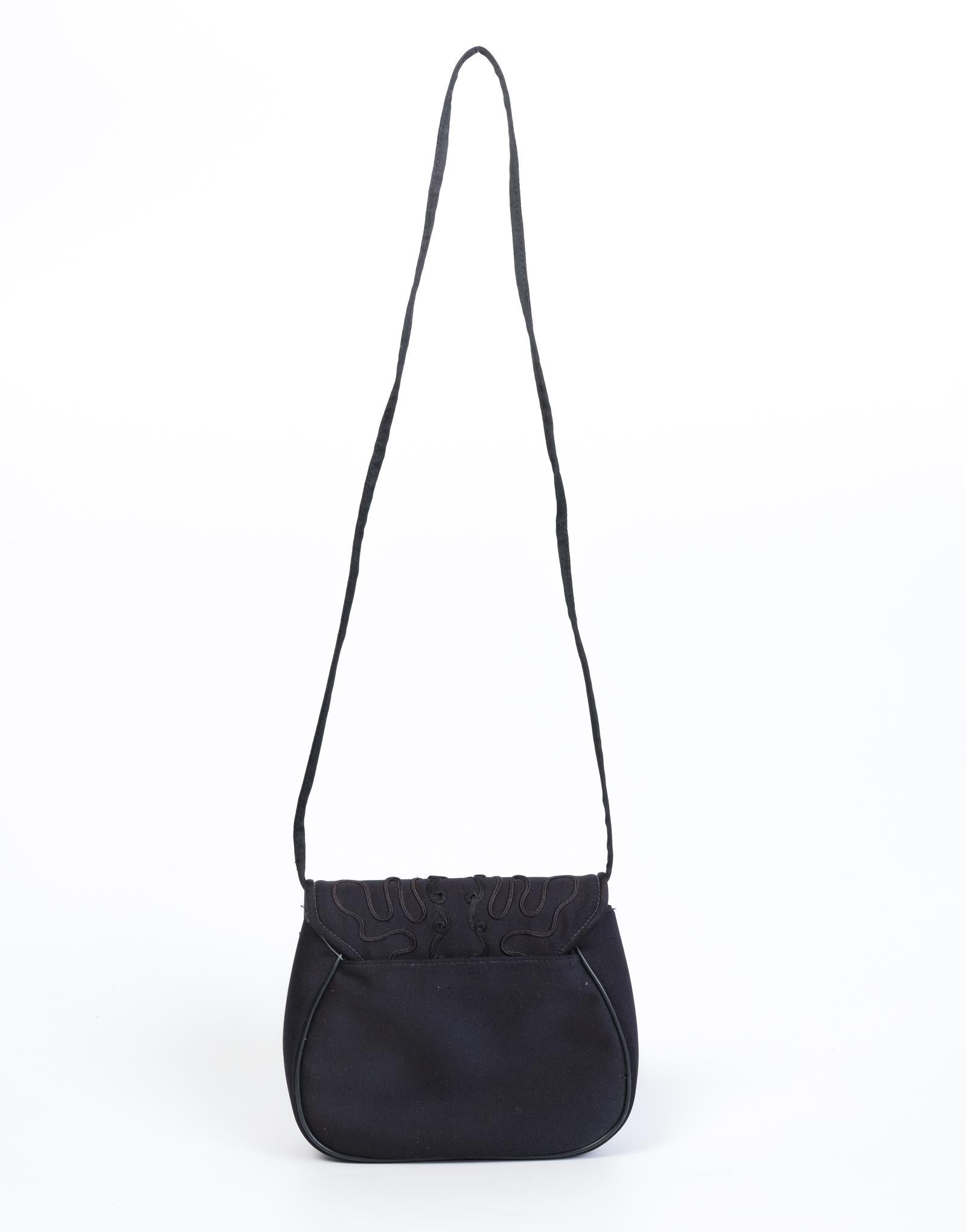This vintage Givenchy bag is made with black satin and features ornate embroidery on the front flap and a long fabric strap for crossbody carry. A classic and sophisticated style.

COLOR: Black
MATERIAL: SATIN
CONDITION: The exterior shows marks on