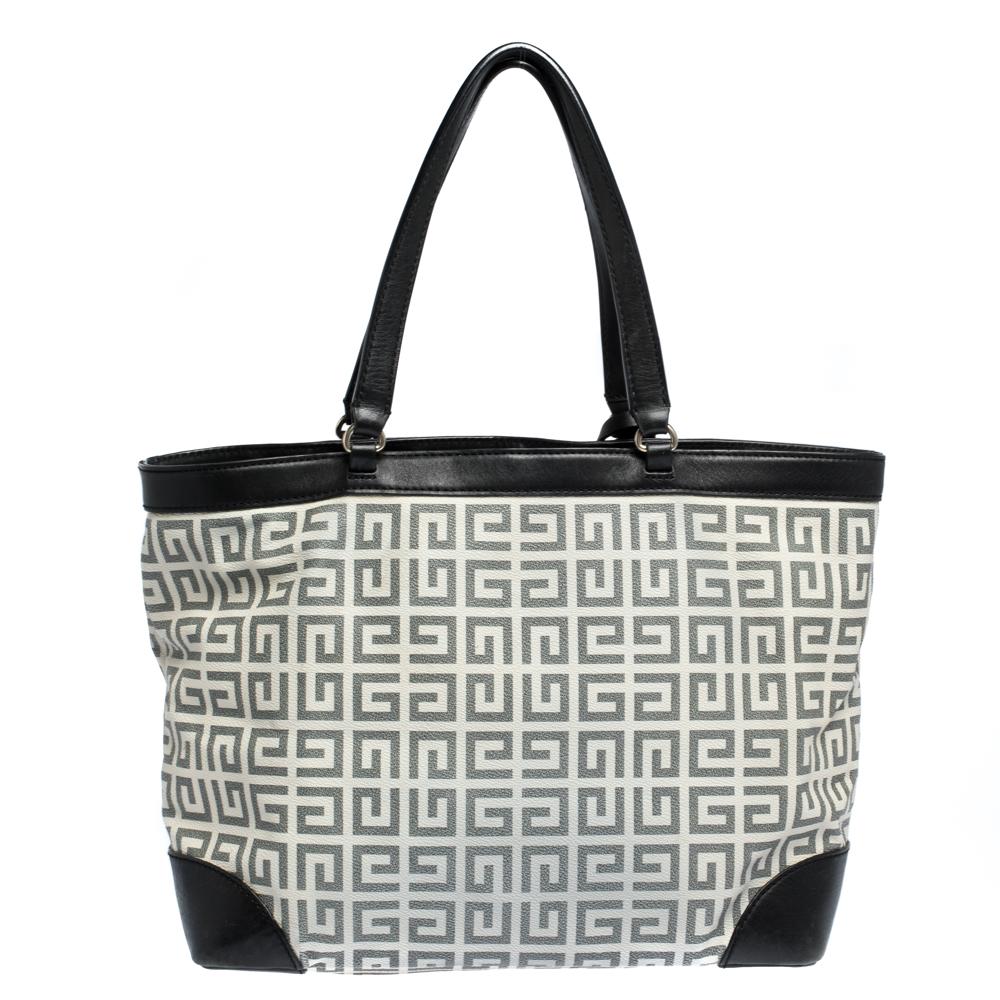 This tote from Givenchy is beautifully crafted in black & white with monogram print all over. The vintage style shoulder bag has sleek mid-length handles with leather bits on the corner and the top border. You can tag along with it with a formal