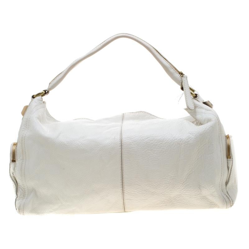 This premium leather bag comes in white color and features an exquisite design with multiple zips detailing at the front. The fabulous canvas lining provides durability. Coming from the house of Givenchy, this piece is a dream come true for every