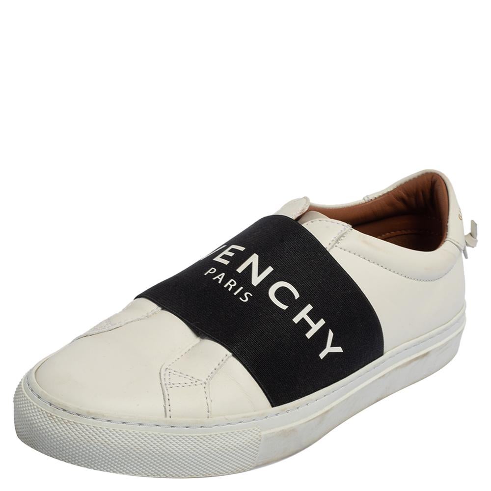 Crafted from white leather, Givenchy's sneakers are cool, casual, and smart. They feature broad vamp straps in black accented with the label's logo. With a slip-on style, round toes, and sturdy rubber soles, these sneakers are a must-buy!

Includes: