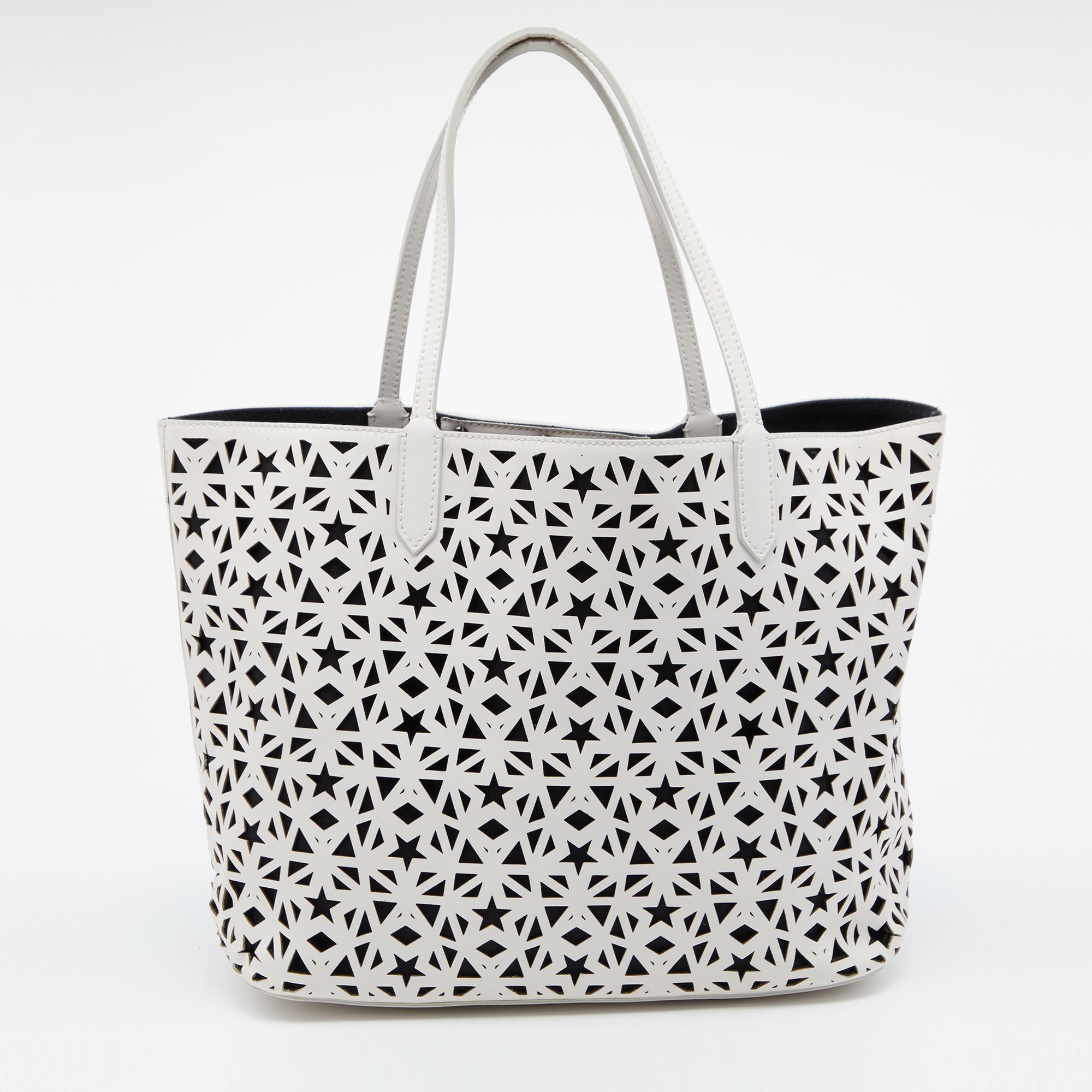 This designer tote from the House of Givenchy is super classy and functional, perfect for everyday use. It is made from perforated leather on the exterior with the label adorning the front. It has two handles.

