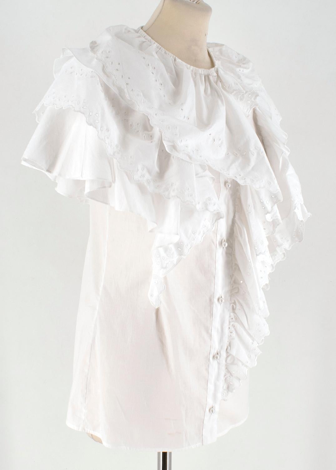 Givenchy White Short Sleeve Ruffled Top 

- Ruffles with embroidered cut outs and hem
- Pearl buttons at the front for closure
- Round neckline

Please note, these items are pre-owned and may show signs of being stored even when unworn and unused.