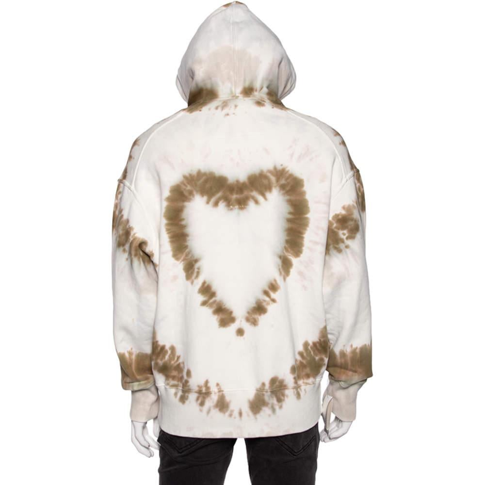 Step out in style with this cool Givenchy oversized hoodie. Coming in a tie-dye heart print, the white hoodie is the epitome of comfort and trendy fashion. It has been made using cotton, which makes it super comfortable and perfect for daily