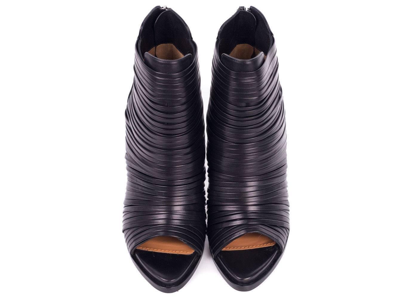 You are the woman of the hour in your leather Givenchy Wrap Strap Booties. These heels feature gathered leather wrap straps and a tasteful peep toe. The perfectly sculpted five inch cone heel add a artistic twist to your conventional heel. Pair this