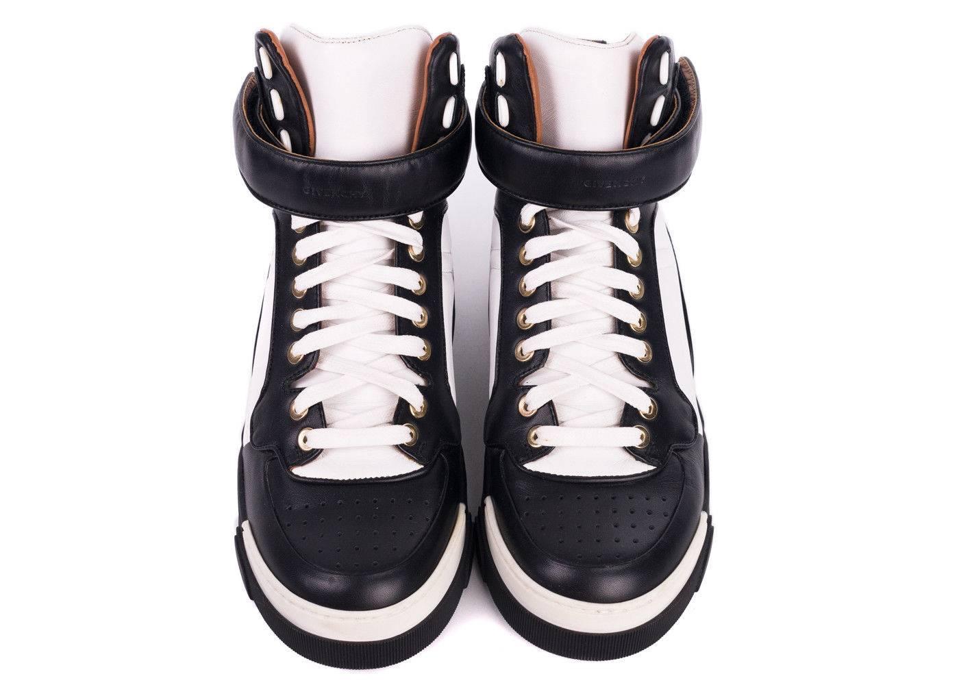 Givenchy's Tyson Colorblock Sneaker is this season's must have. This high top sneaker features Givenchy's signature logo engraved strap , genuine black and white colorblocked leather. You can pair these sneakers with leather pants and a moto jacket