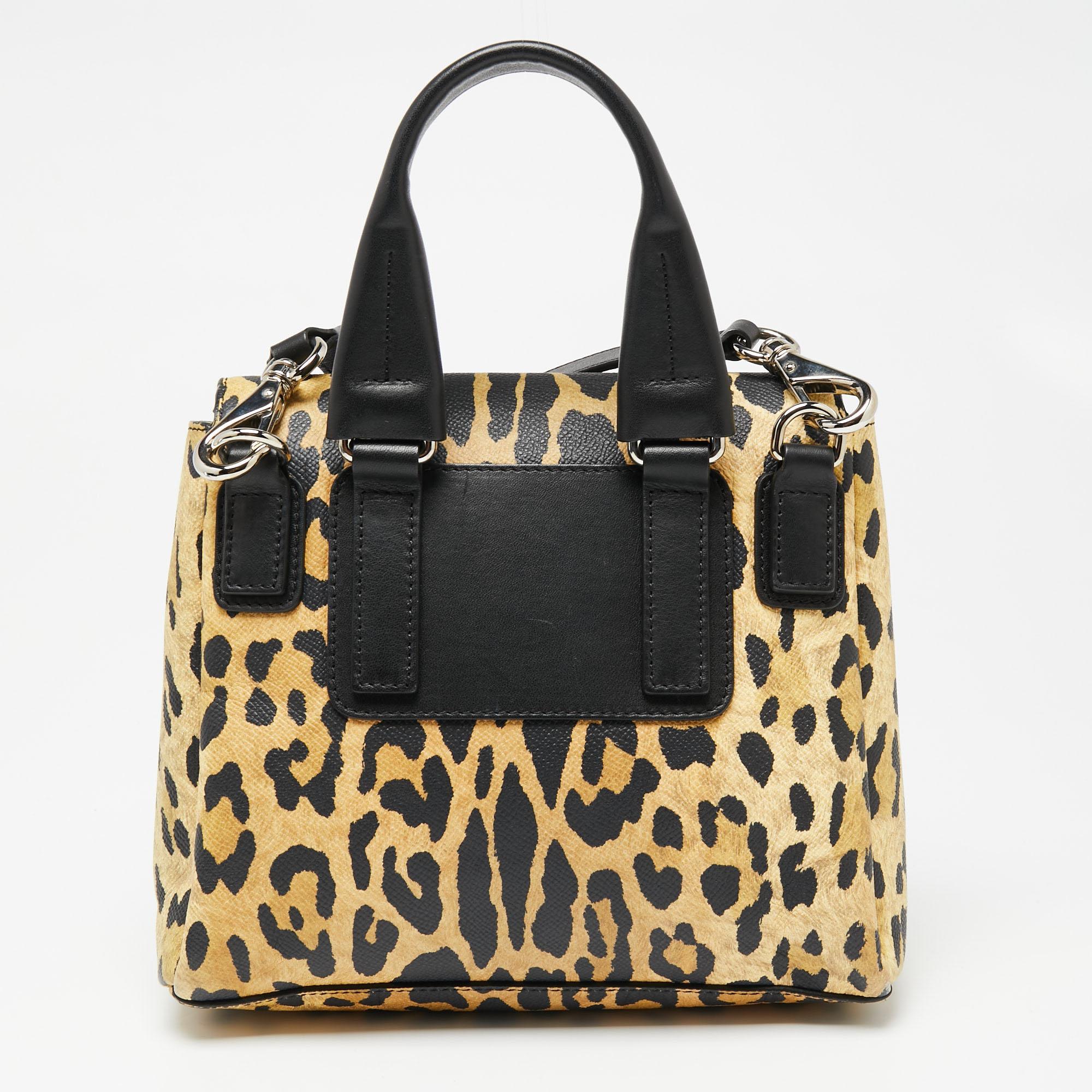 This bag from Givenchy in leopard print is stylish and functional. Crafted from leather, it features a front flap, a detachable shoulder strap, and a top handle. The insides are canvas-lined and the bag is complete with the brand logo on the