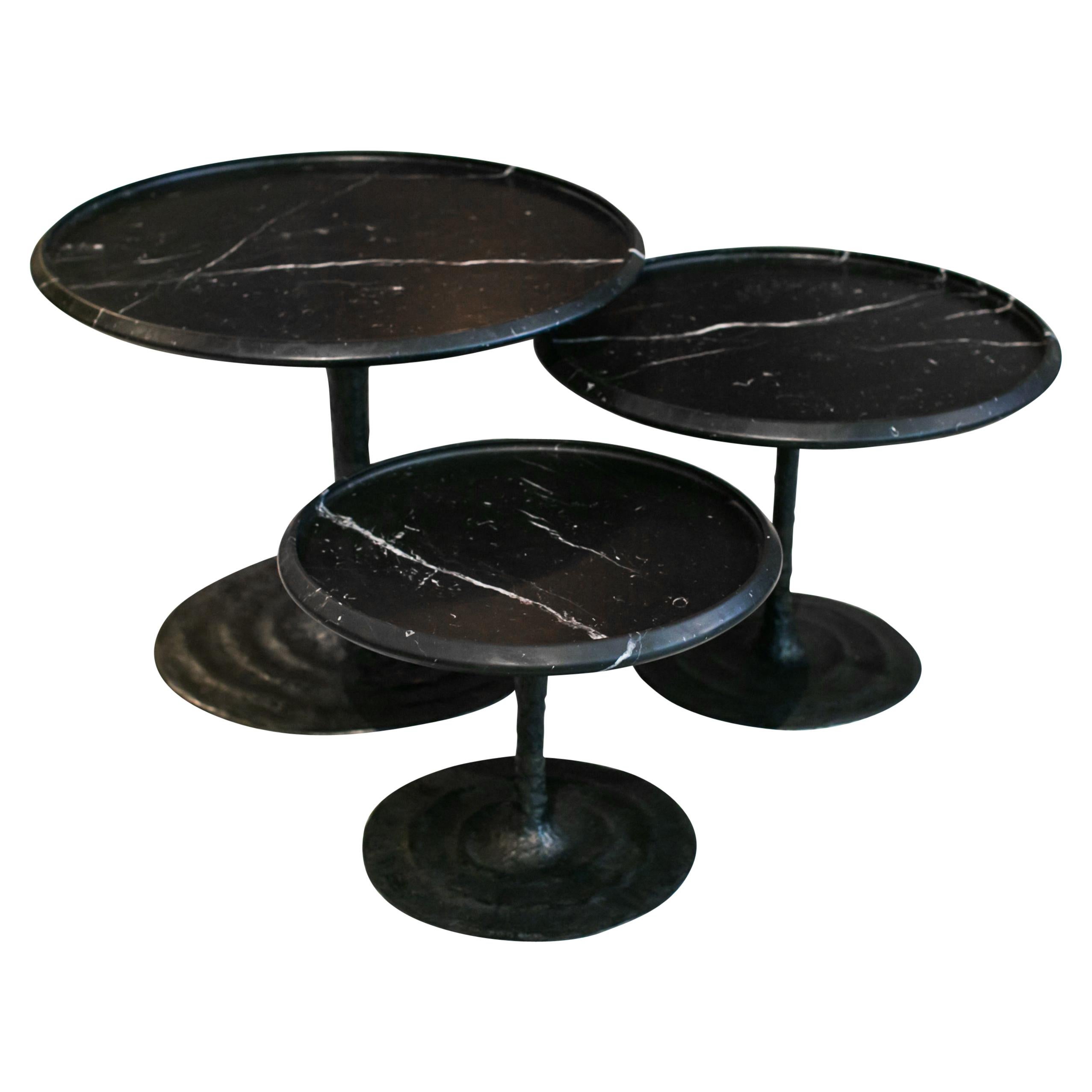 Edition signed, the Giverny tables are a series of nesting coffee tables inspired by the ne´nuphars (waterlilies) of Monet's house in Giverny. The movement carved at the bronze foot evoke the water movement. Their elegant silhouettes and detailed