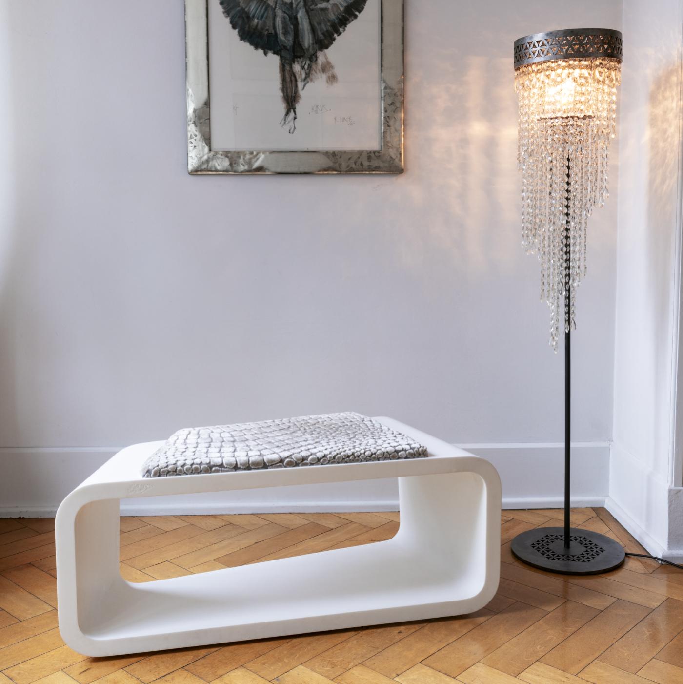 Marked by a skewed rectangular shape that results from skilled hand-craftsmanship and technological precision, this bench is entirely made of a single piece of high-gloss white CorianÂ, a patented acrylic polymer composite. The top features a brown