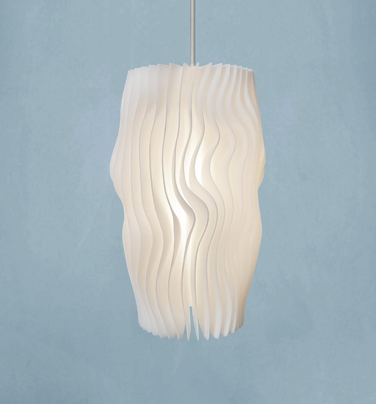 This object is a limited edition (1/330) Swiss Design pendant lamp from the first Glacier series - inspired by the organic shape of glacial ice layers - brand new in the box with certificate and International Lifetime Warranty, several consecutively