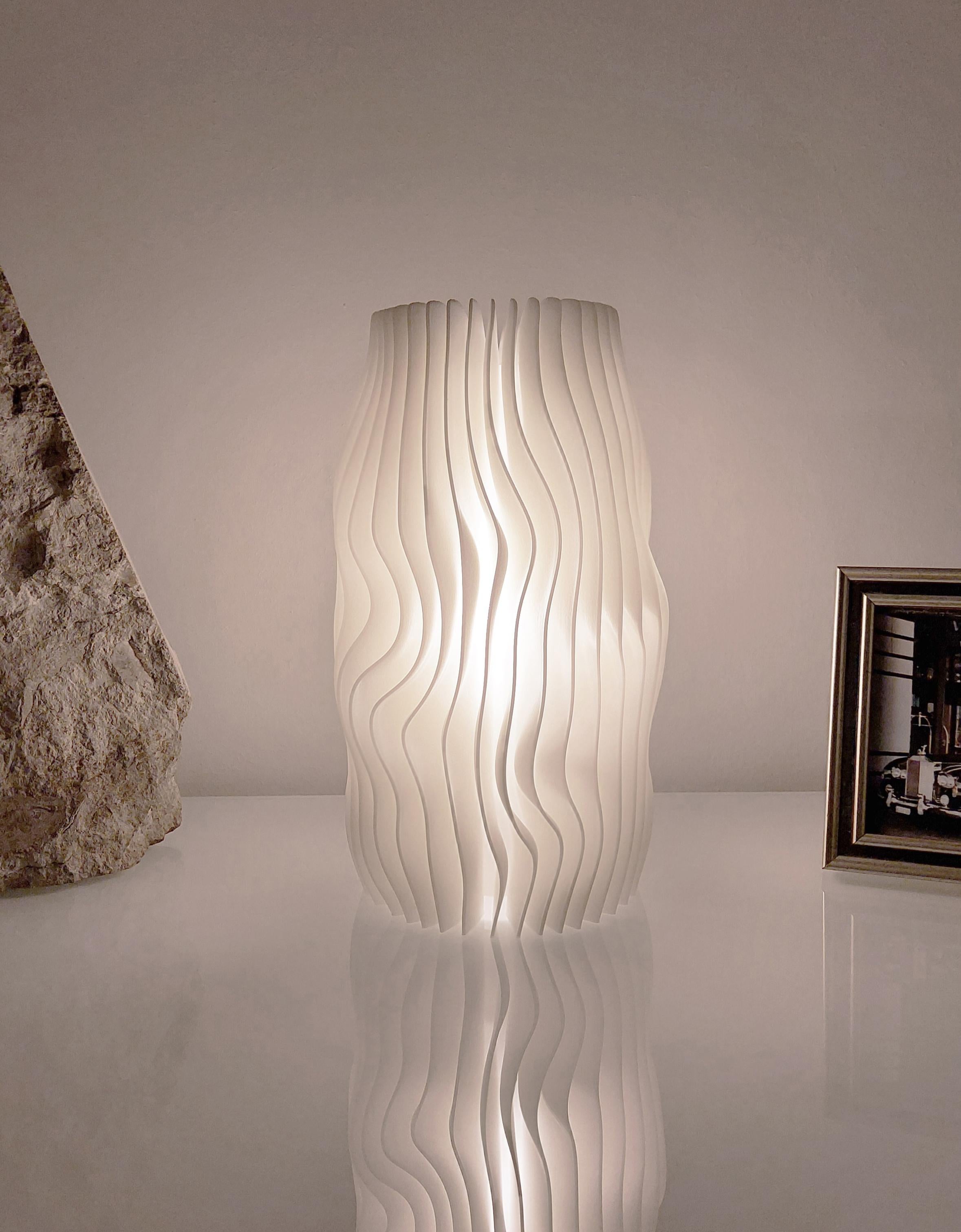 This object is a limited edition (1/330) Swiss Design table lamp from the first Glacier series - inspired by the organic shape of glacial ice layers - brand new in the box with certificate and International Lifetime Warranty, several consecutively