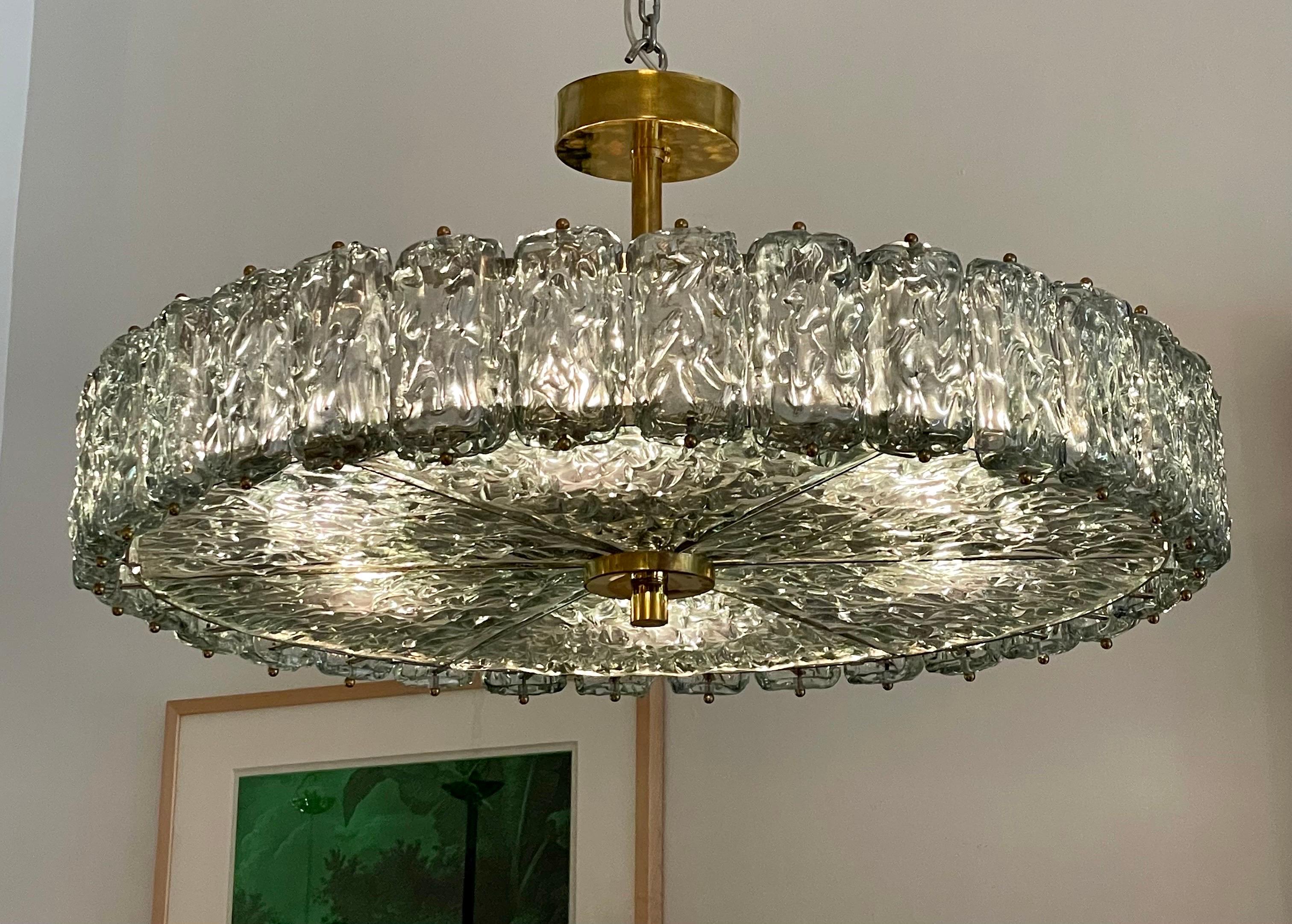 This is a semi-flush ceiling mounted chandelier covered entirely in exquisite glacier blue toned glass - style of Carl Fagerlund for Orrefors. A great scale. Brass trim to bottom and top. Six lights provide ample light - fully rewired for easy