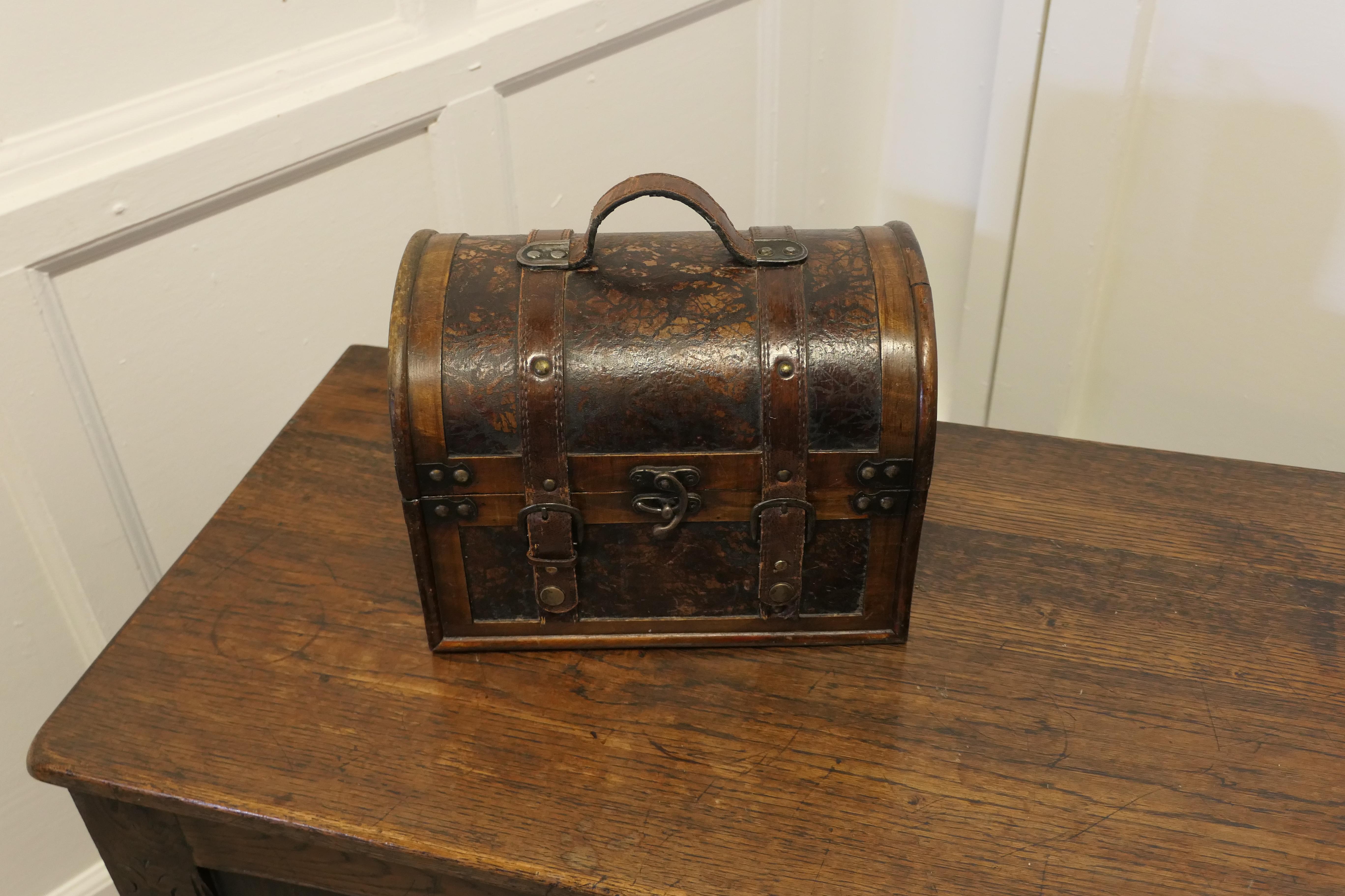 Gladstone bag treasure chest box.

Designed to look like a Gladstone bag, this useful little storage box, would make an excellent jewellery or treasure chest. 
Made in wood and Leather and in good lightly used condition.
The box is 10” tall, 12”