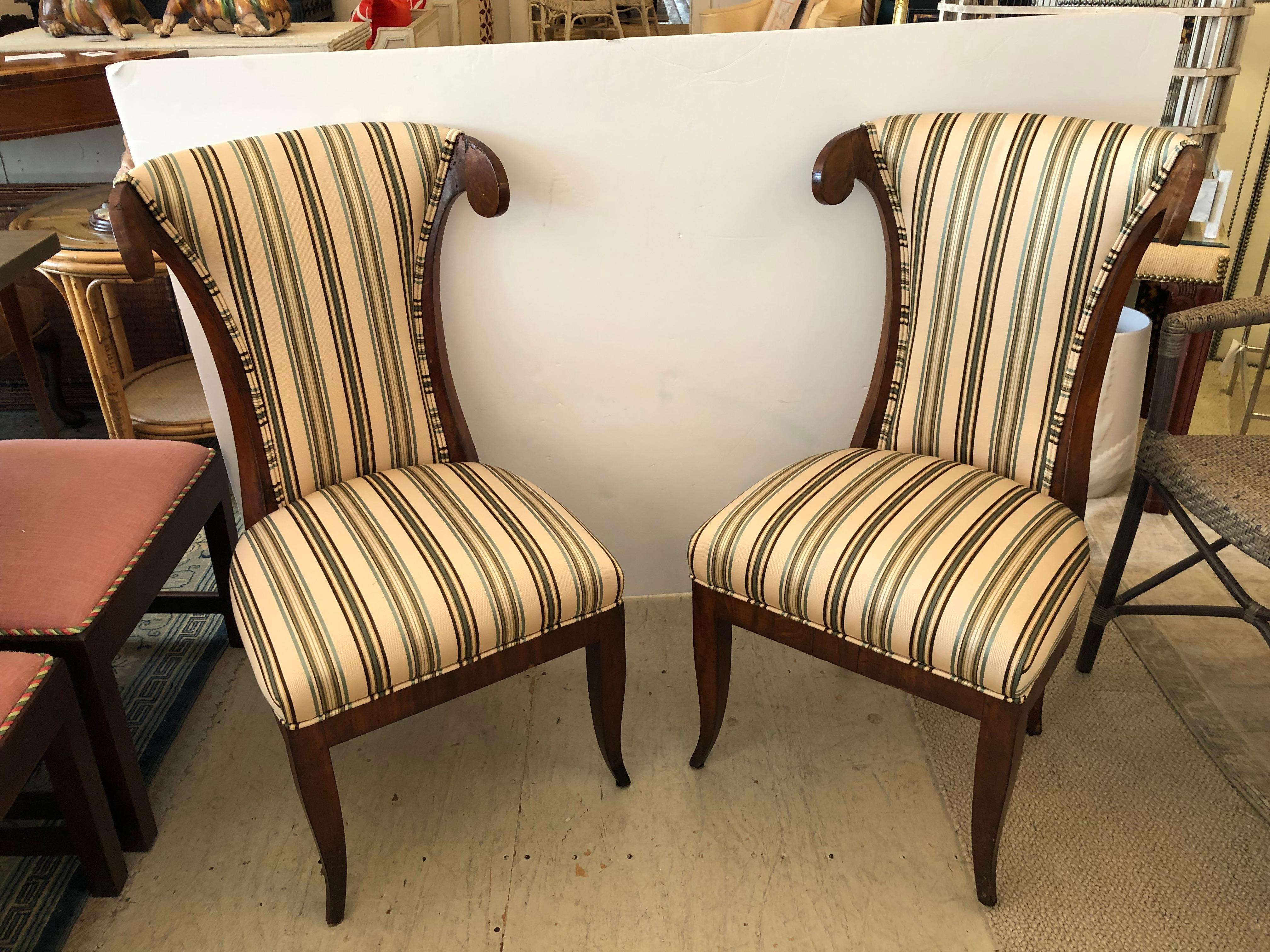 Great looking vintage pair of walnut klismos style chairs having elongated backs with curved tops, slightly splayed front legs, and new sassy striped upholstery.

Measures: seat w 19 seat height 17 seat depth 16.
