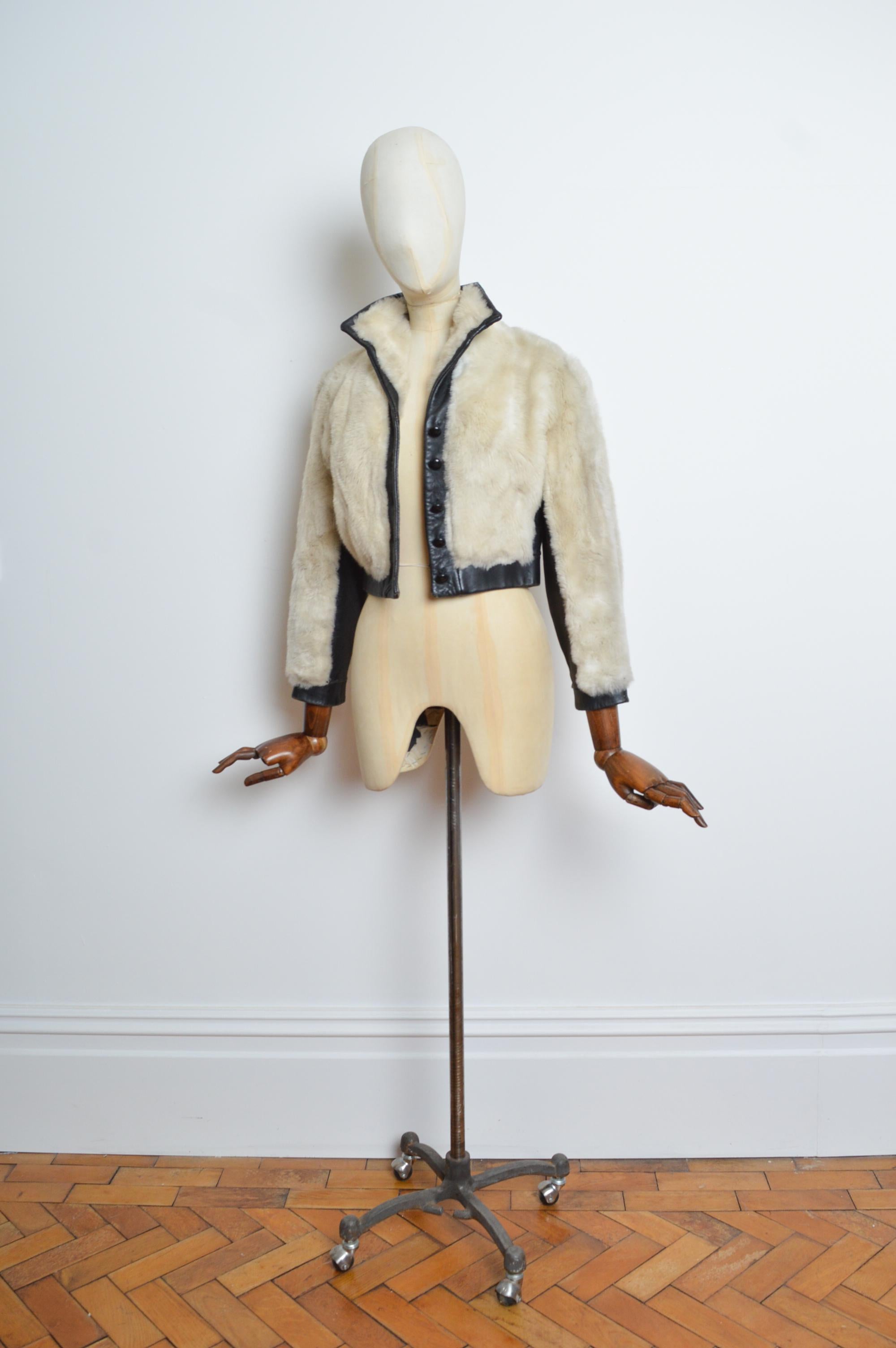 Fabulous 1970’s Glam Rock faux-fur bomber, with intercepting Leather panels, buttons down the front & crimson rayon lining. 
Size; XS / UK 6
Measurements are provided in inches (‘’)
Pit to Pit; 18’’
Pit to Cuff; 16’’
Nape to Hem; 19’’
Waist; Upto