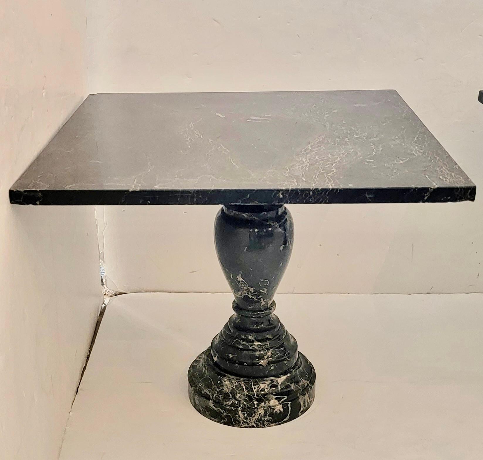 Gorgeous pair of heavy square black marble end tables having urn motif bases and handsome white graining.  Tops come off for easier moving.
Note:  The matching tables are slightly differing in size.  The smaller one is 21.5 square;  larger 23