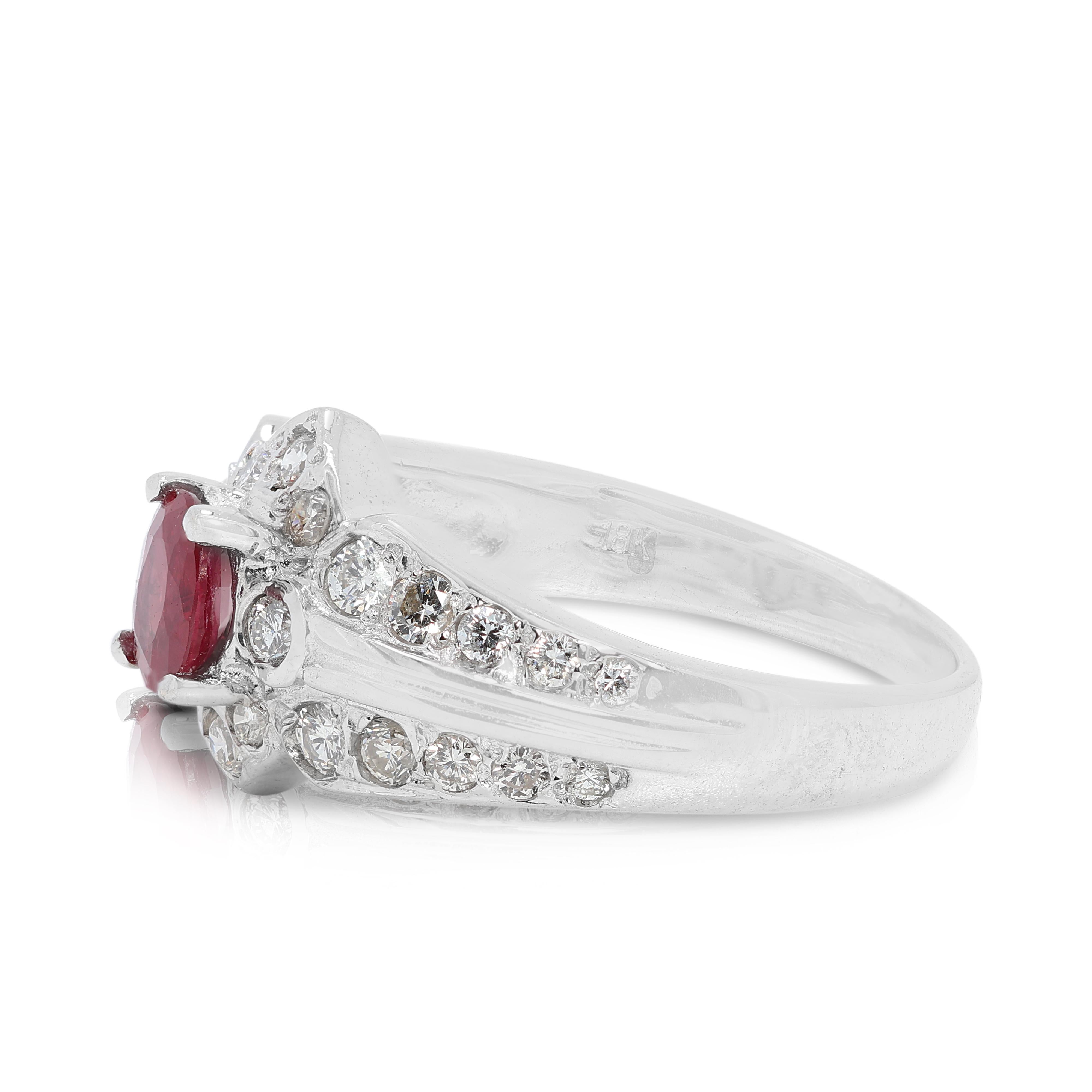 This stunning 18K White Gold ring features a 0.28-carat oval-shaped ruby, radiating a rich red hue that serves as the centrepiece of this elegant design. The ruby is beautifully complemented by 28 round brilliant diamonds, with a combined weight of