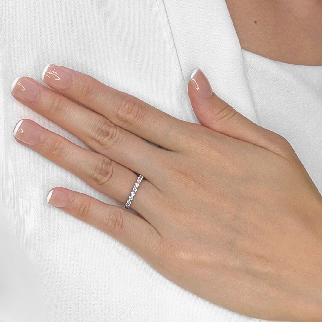 A stunning celebration of everlasting elegance, this eternity ring is masterfully crafted in 18K white gold, adorned with 11 round brilliant-cut natural diamonds, totaling 0.51 carats. Each diamond, with its H-I color grade and VS-SI clarity, is