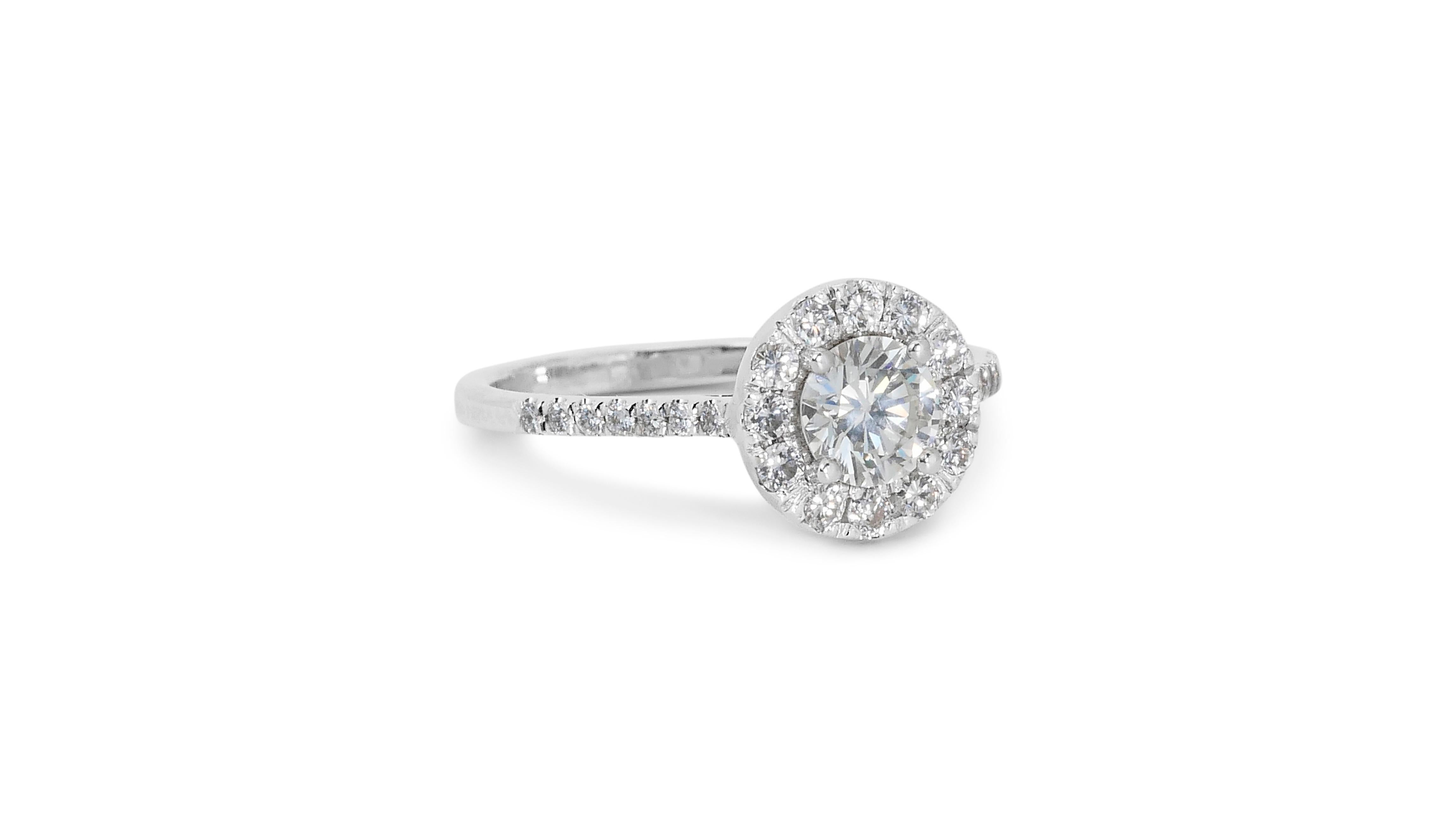 Glamorous 1.30ct Diamonds Halo Ring in 18k White Gold - GIA Certified

This breathtaking diamond halo ring, expertly crafted in lustrous 18K white gold, showcases a stunning 1.00-carat round brilliant main diamond. Encircling the central diamond are