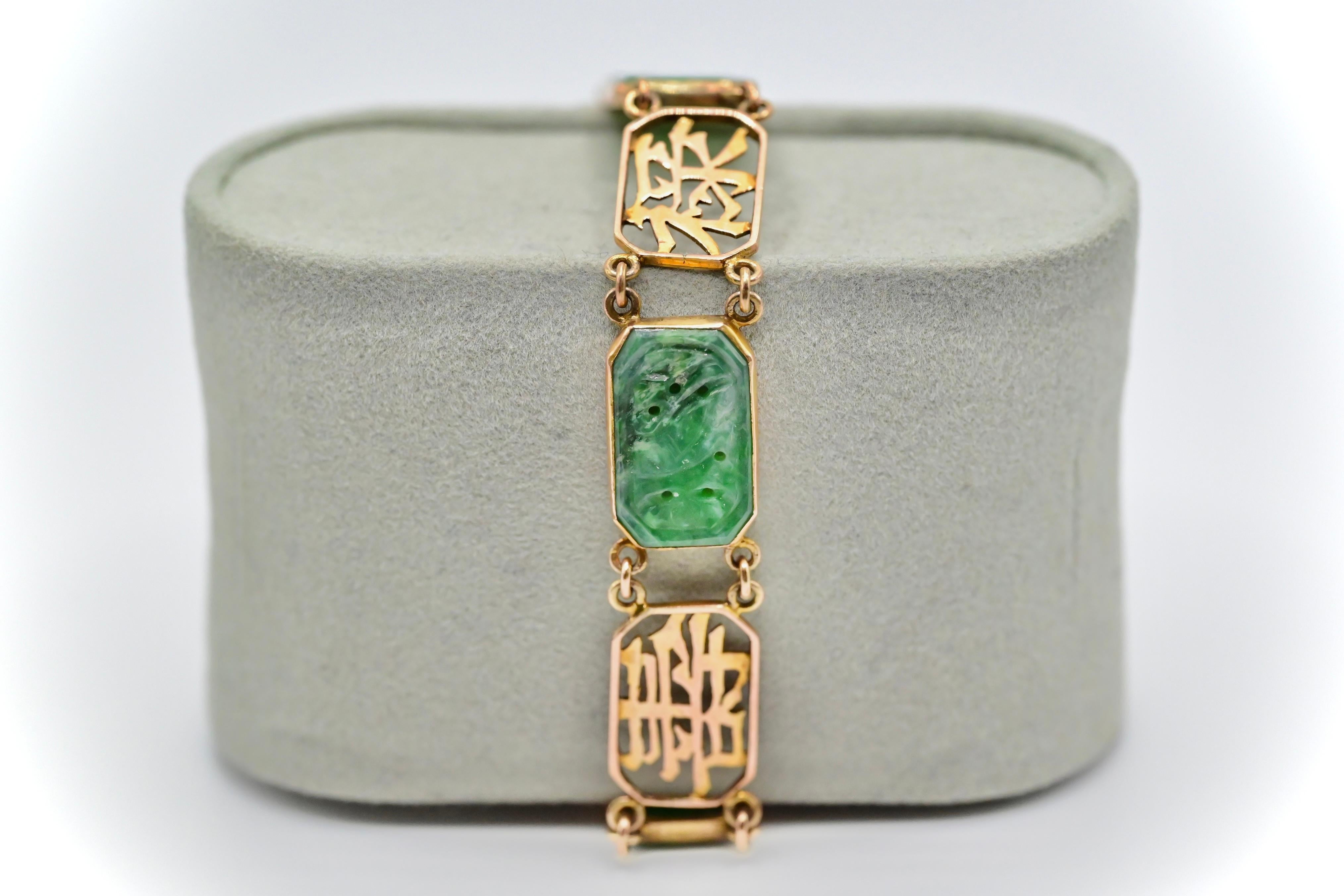 This is a gorgeous 14k yellow gold bracelet made with exquisite carved green jade, and gold cut out Chinese characters going around the bracelet. The bracelet is in good condition with small wears. It weighs 11 grams, and stands at 12mm tall. If you