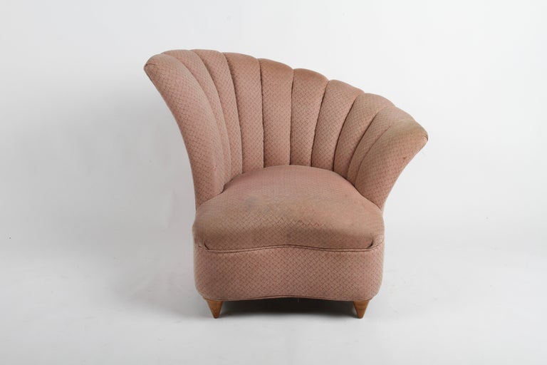 Glamorous 1940s Hollywood Regency asymmetrical scallop back slipper or lounge chair on tapered cone front legs. Older reupholstery shows wear, tears and stains, legs shown wear should be refinished.