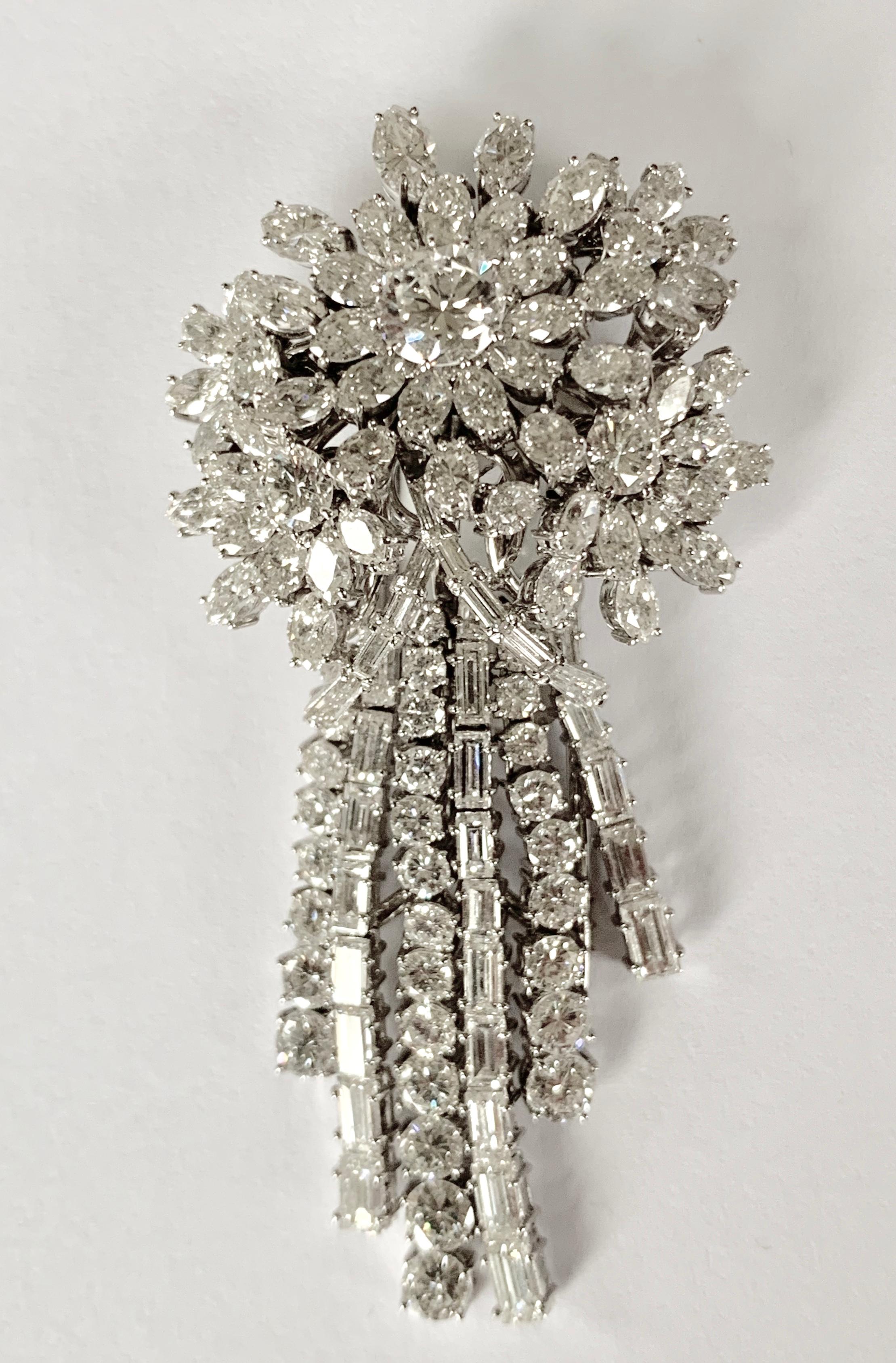 18 K white gold diamond brooch in cascade style, containing 110 diamonds in pear shape, baguette, marquise cut and brilliant cut totaling approximately 8.00 ct, G colors clarity. 