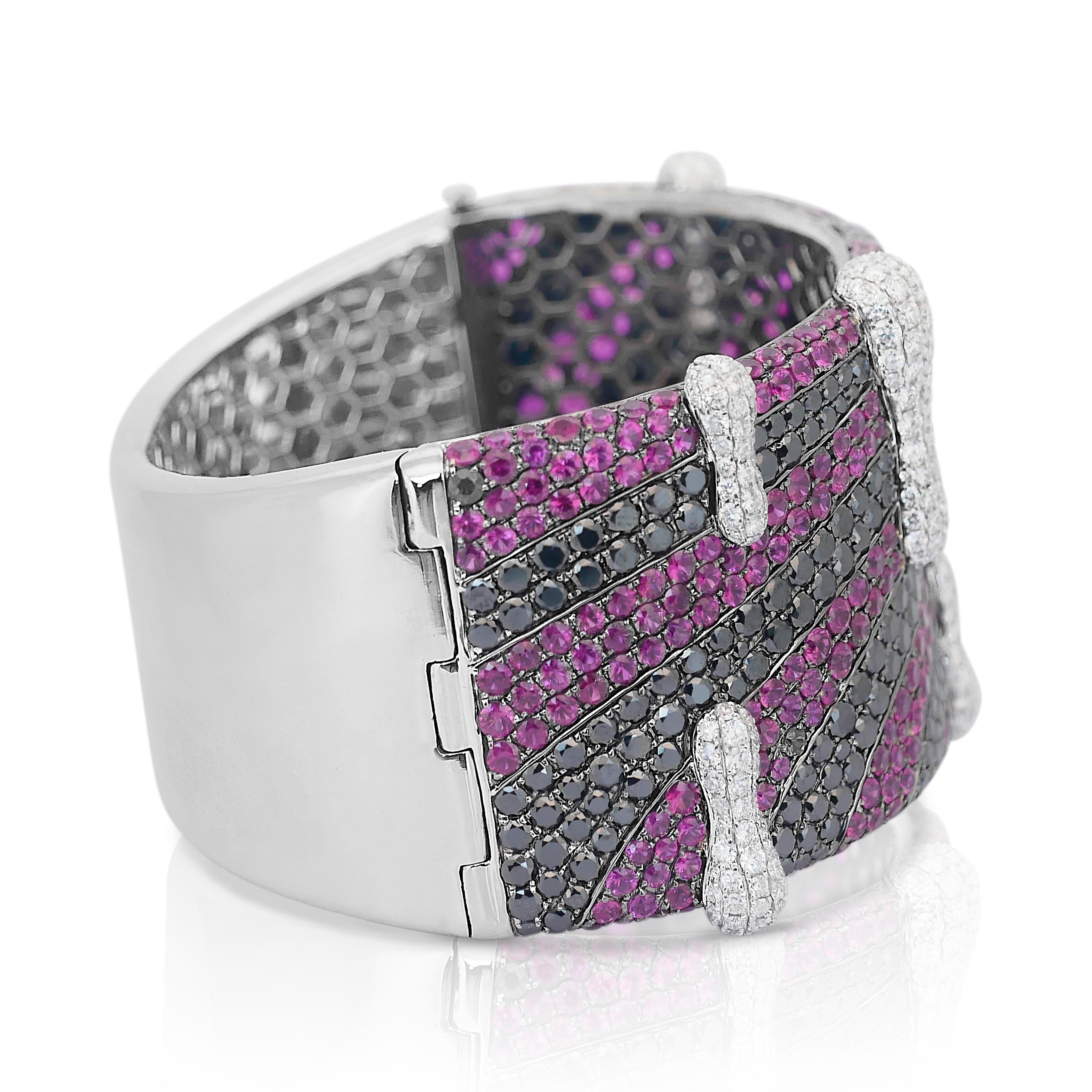 Glamorous 35.50ct Rubies and Natural Diamonds Bangle in 18k White Gold - IGI Certified

Make a statement with this exquisite 18k white gold bangle, showcasing 266 round rubies totaling 15.00ct in a rich purplish-red hue, exuding timeless elegance.