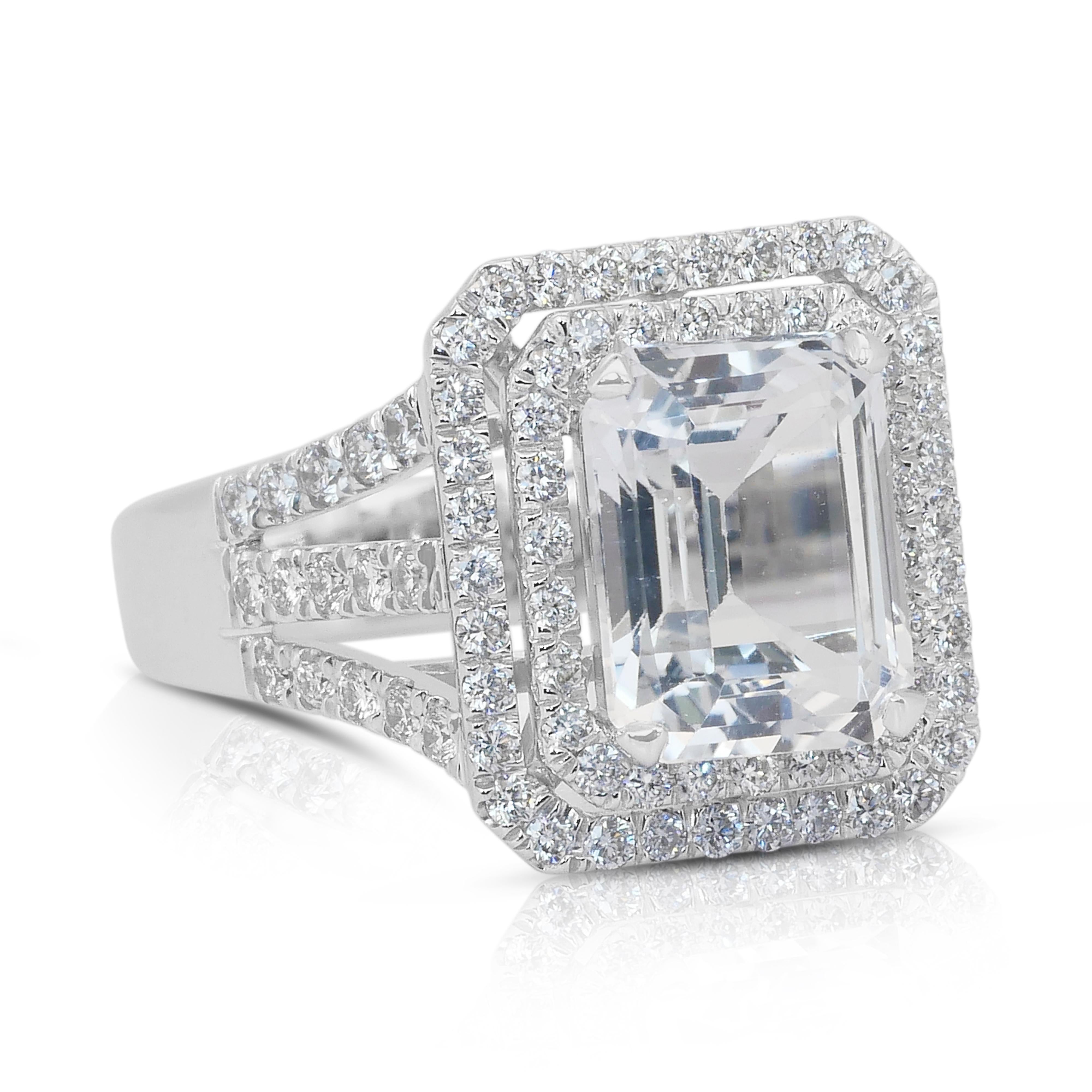 Glamorous 7.62ct Topaz and Diamonds Double Halo Ring in 18k White Gold - IGI Certified

Command attention with this stunning double halo ring, crafted in sleek 18k white gold. At its center lies a magnificent 5.02ct emerald-cut topaz. Encircling the