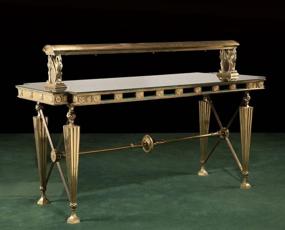 An American bronze and glass banking table
Early 20th century
Each Greco-Roman-style, the table with a rectangular notched-corner top with a medallion designed apron, four legs, cross members at each end, and a central support with center roundel,