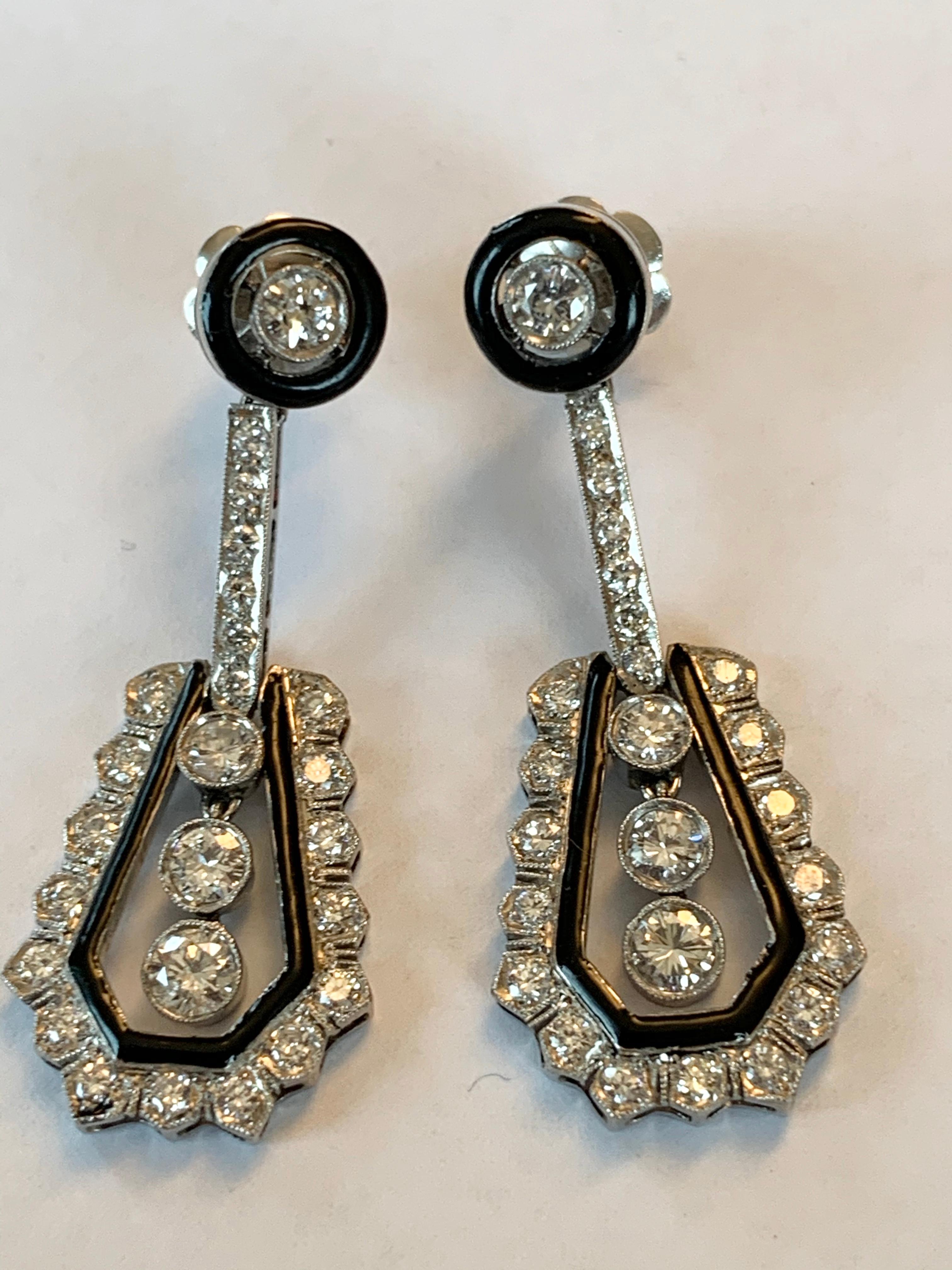 Sign of Distinction and understatement. A pair of Platinum Art Déco Diamond and Enamel pendant earrings. The row of 3 diamonds in the centre move gently when worn. 