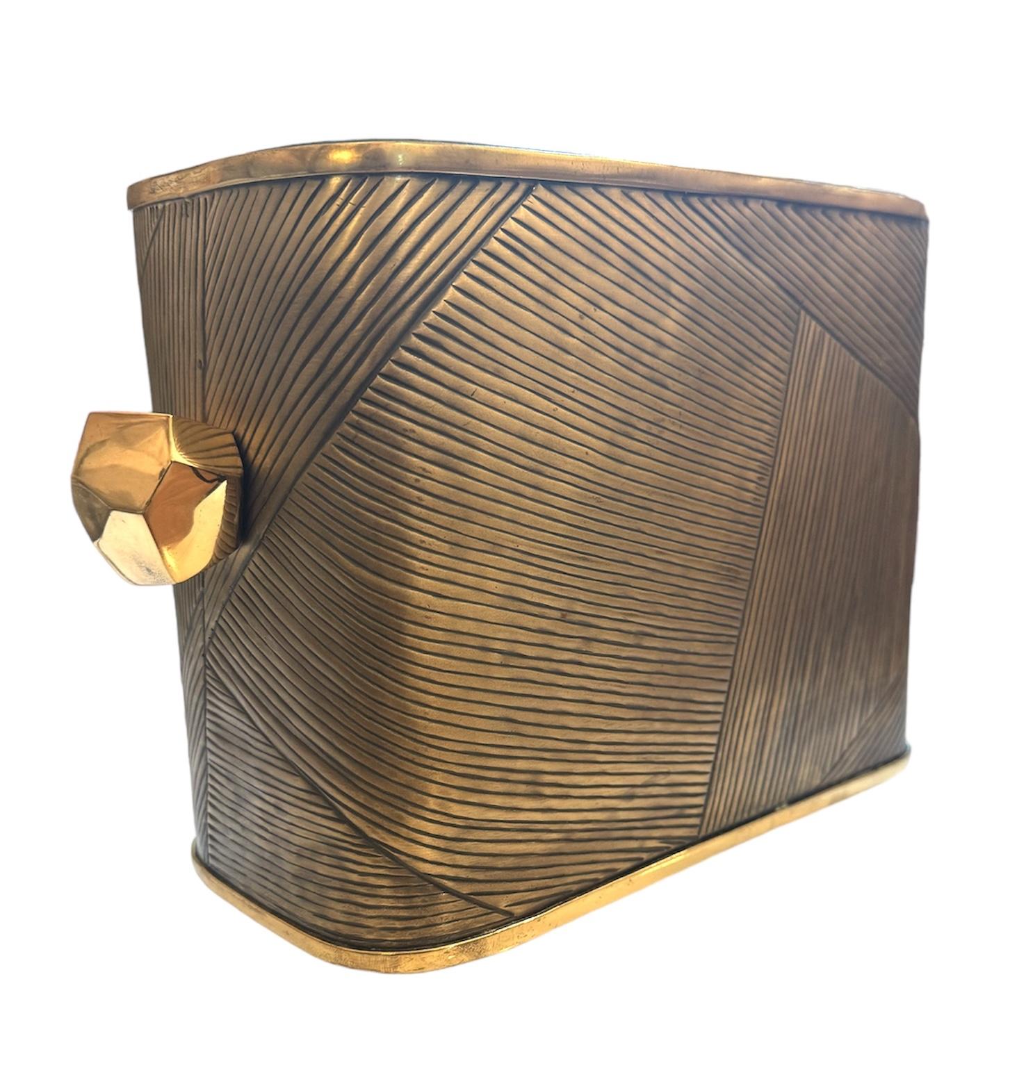 Elevate your entertaining experience with this exquisite solid brass ice bucket, a testament to luxury and craftsmanship. Designed by the renowned Jay Jeffers, this rectangular masterpiece exudes sophistication and style. Its generous size