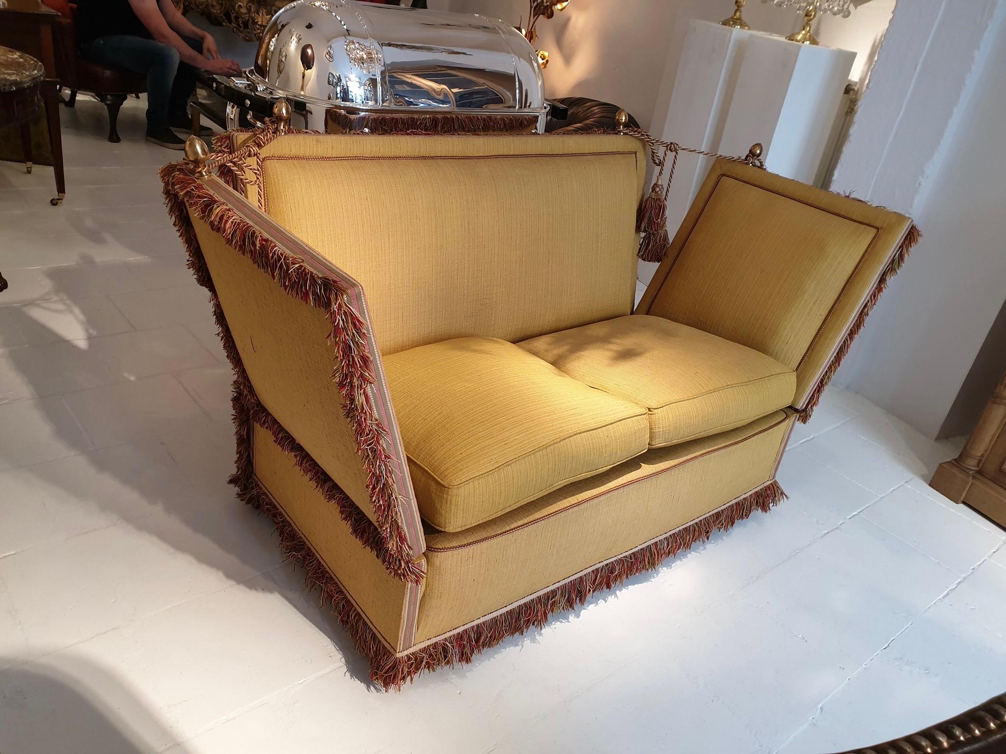 Very glamorous Classic Knole style sofa upholstered in a beautiful soft shade of goldish yellow fabric.
The Knole sofa or settee originated in England in the late 1700s and is still being produced to this day which says something about the Classic