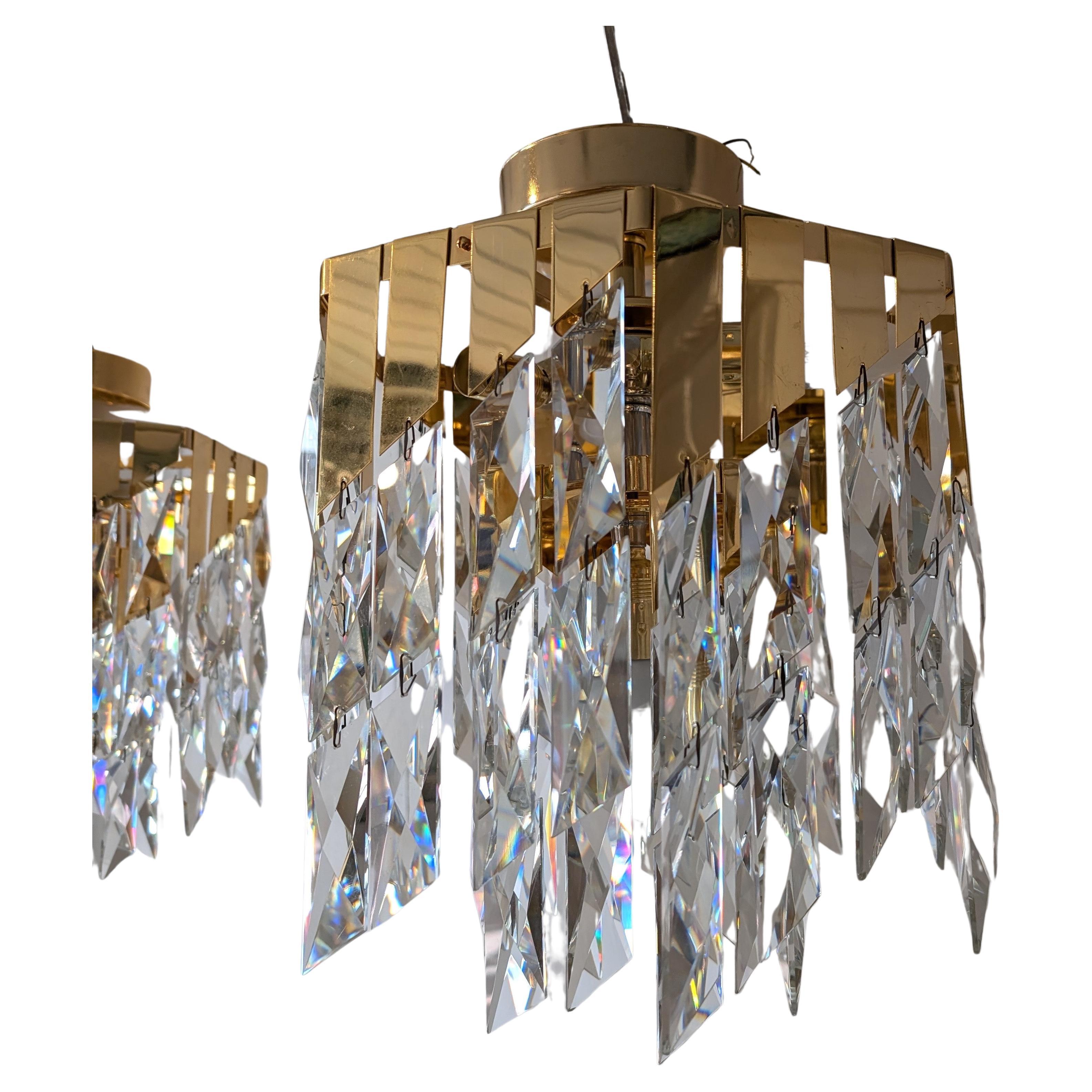 Super glamorous cut glass and gold metal 1980s American chandelier. Only ONE is now available.
The drops are great quality: heavy cut glass rhomboid shapes, on corresponding graduating gold tabs. Newly rewired and ready to hang.
Some tiny chips on a