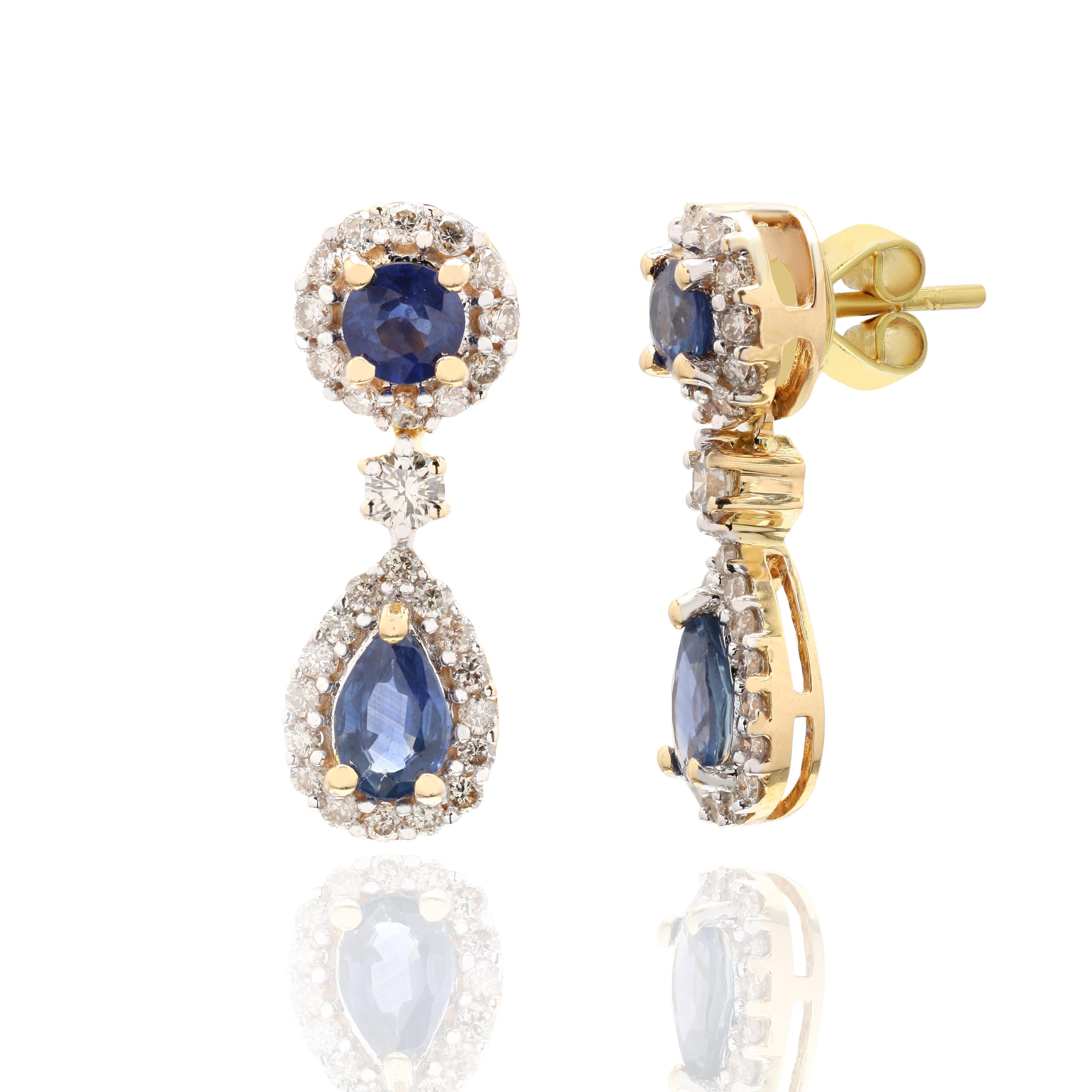Diamond Blue Sapphire Dangle Earrings in 18K Gold to make a statement with your look. These earrings create a sparkling, luxurious look featuring round and oval cut gemstone.
Sapphire stimulates concentration and reduces stress. 
Designed with