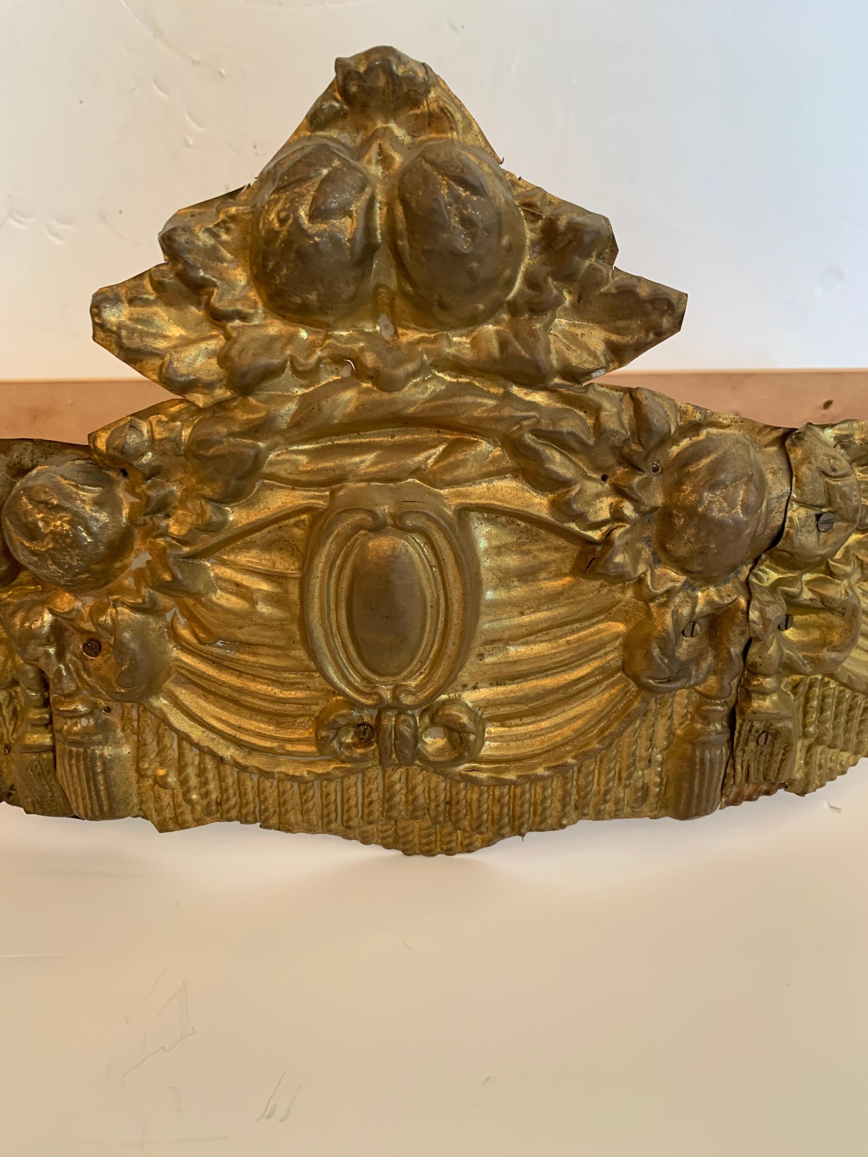 Sleep like royalty with this sweet little gilt metal bed crown. A close relative of the four poster canopy bed, the corona is meant to drape curtains over the bed, making it a focal point, but originally developed for more practical reasons. Drapery