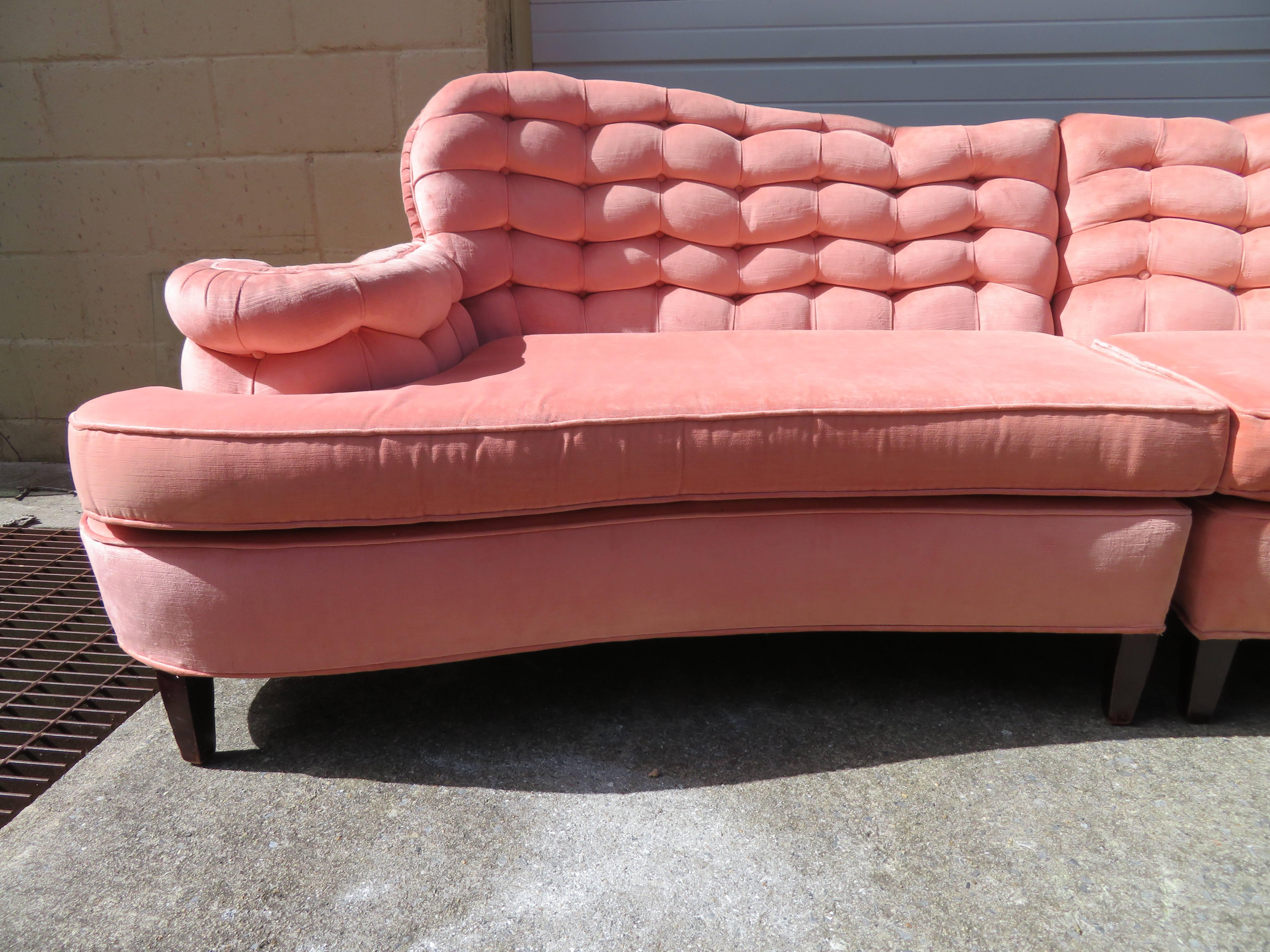 Truly stunning Dorothy Draper attributed scrolled arm curved two-piece biscuit tufted back sofa. This is one of those pieces that actually makes your heart skip a beat when you see it. The original pink velvet fabric still looks lovely-just some