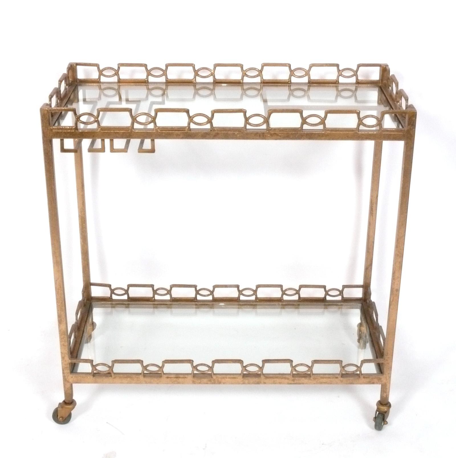 Glamourous Gilt or Gilt Painted Metal Bar Cart, Italy, circa 2000s. It is a versatile size and would make a great cocktail bar or serving cart, or in a home office as rolling storage.
