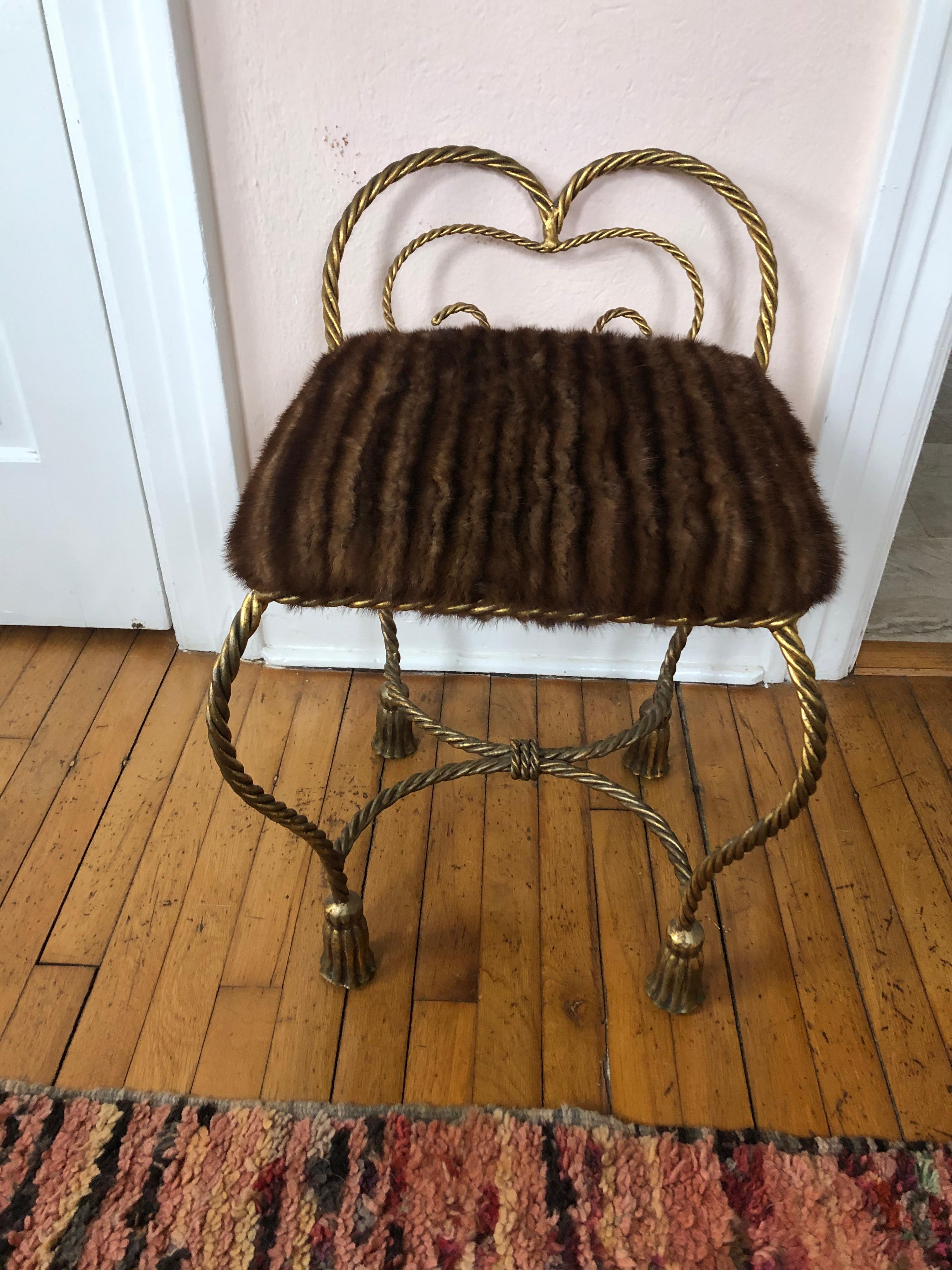 A movie star vintage Italian gilt iron rope and tassel motife boudoir bench or stool, beautifully upholstered in real mink fur. Makes a great little extra seat if used as a floating stool in a living room.