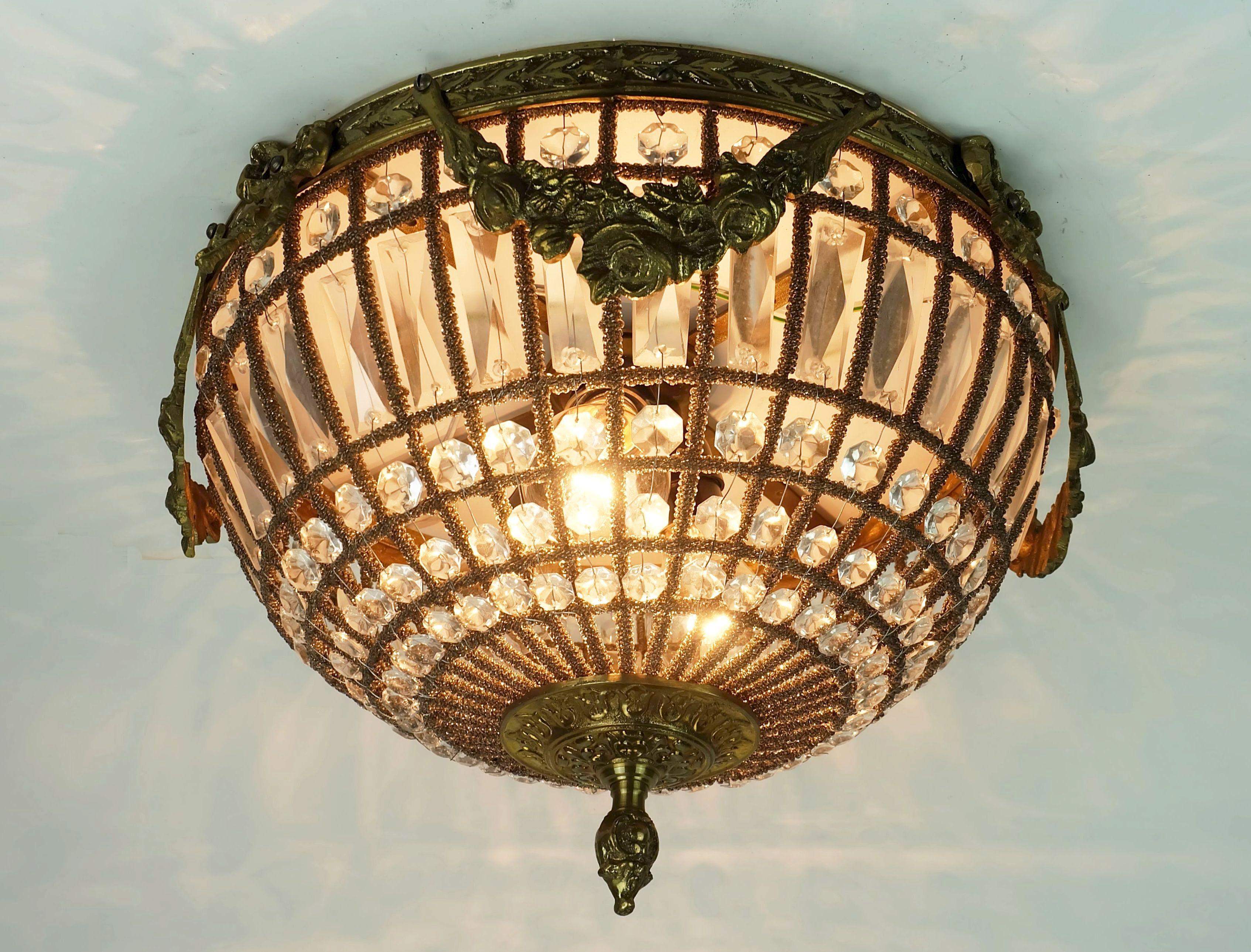 Stylish and glamorous ceiling light from the 1960s and 70s. The shade consists of a rod whose individual rods are wrapped with threads strung with tiny glass beads. The spaces between them are filled with long rectangular and small octagonal glass
