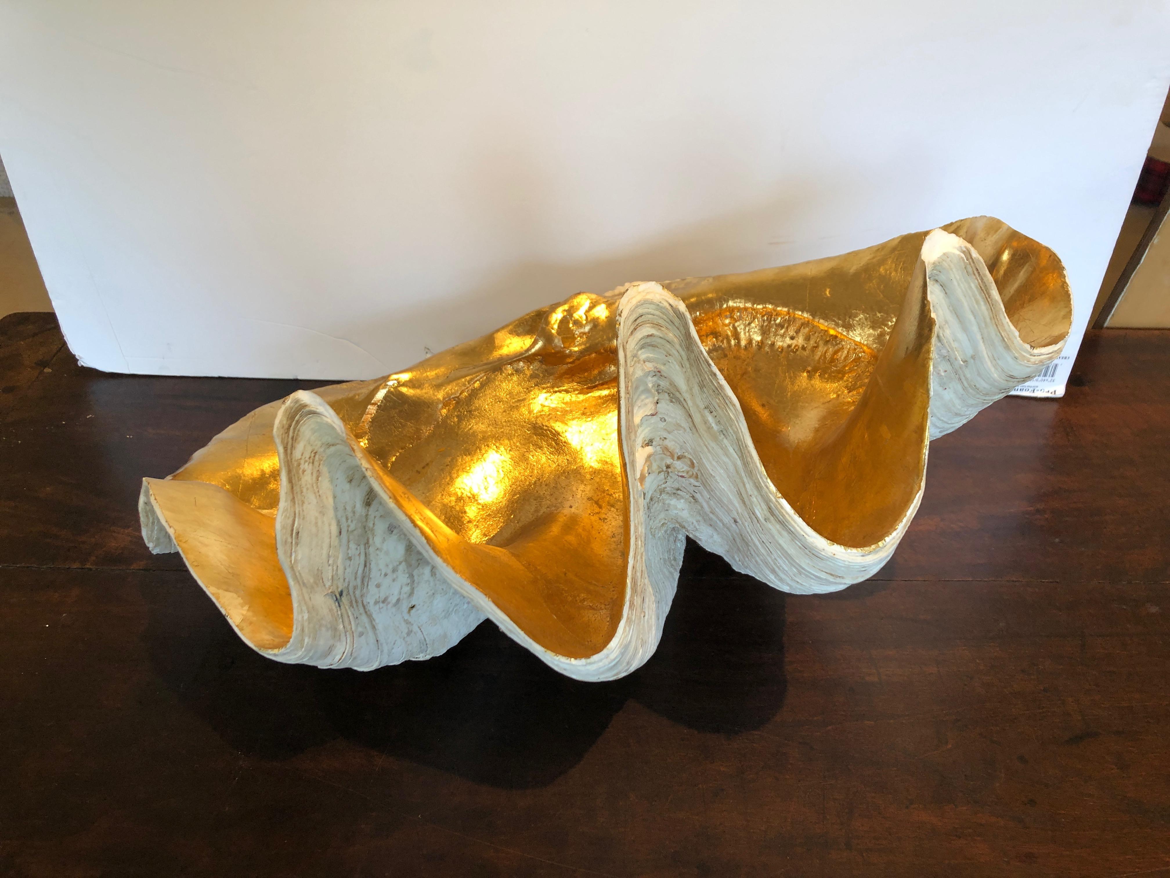 A magnificent tabletop accessory sculpture that originated as an authentic impressively large clam shell, newly glamorized by hand with gold leaf on the interior.