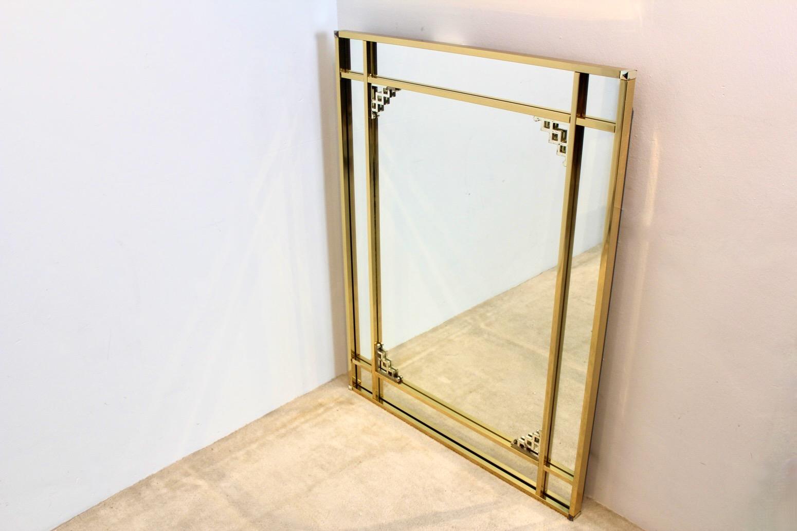 Beautiful Large Brass framed Mirror with chromed inlay and sophisticated Graphical design. Made in Belgium by Belgochrom in the 1970s. The table is a unique example of the Hollywood Regency style. The frame has some wear on the chrome due to normal