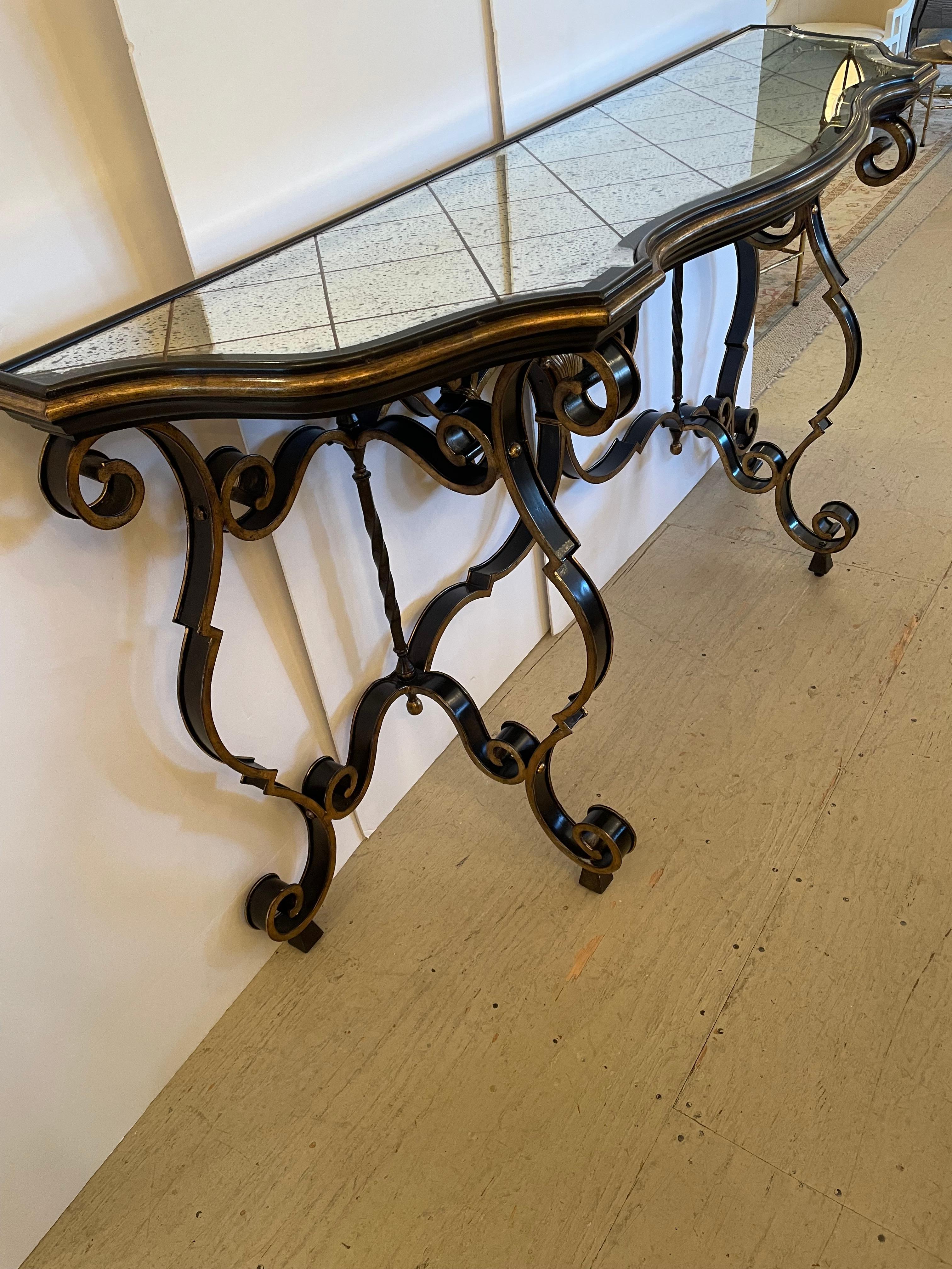 Eye popping glam describes this large black and gold painted iron console table having stunning beveled aged mirror top with diamond pattern.